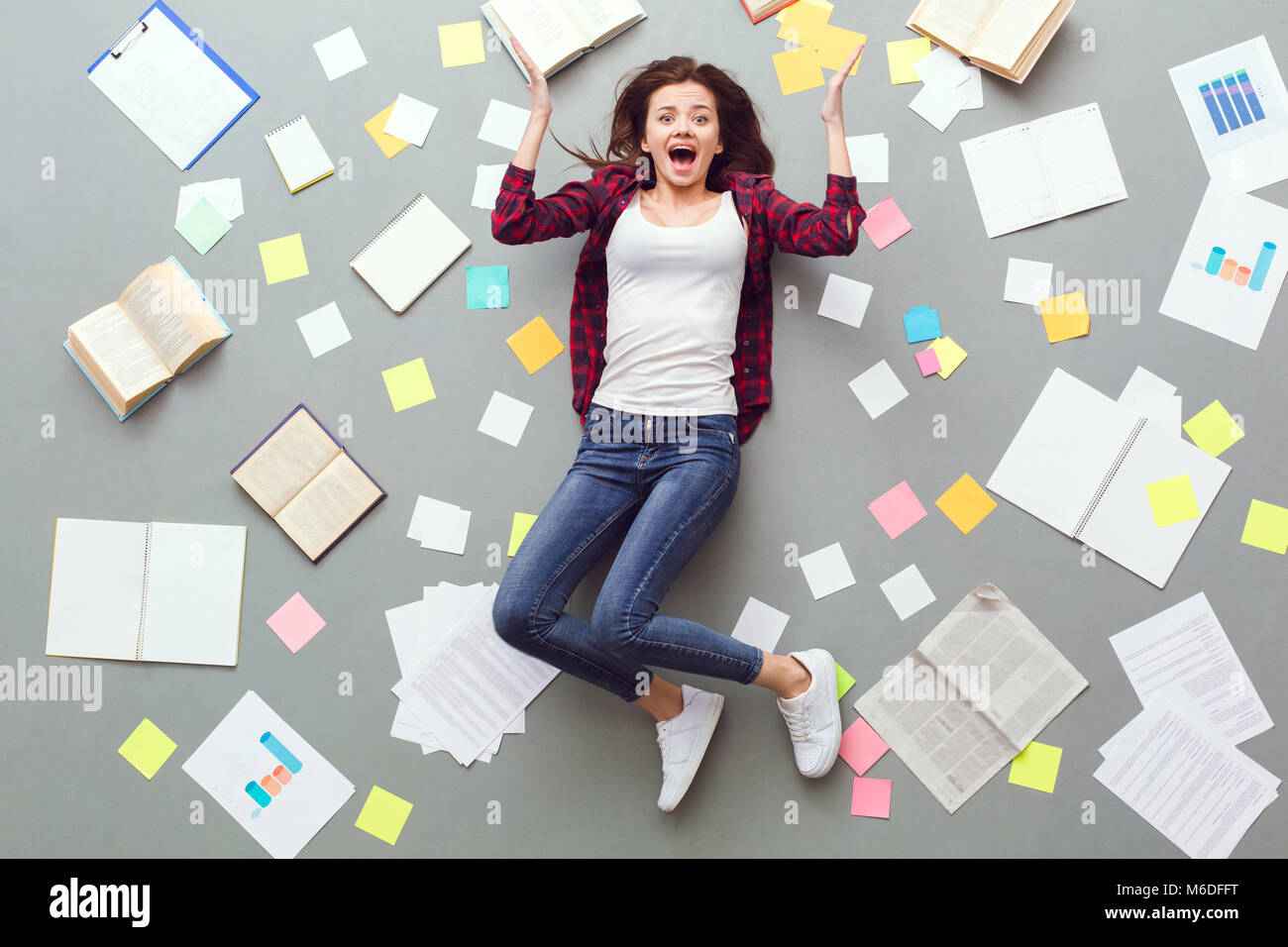 Young woman top view isolated on grey screaming exhausted Stock Photo