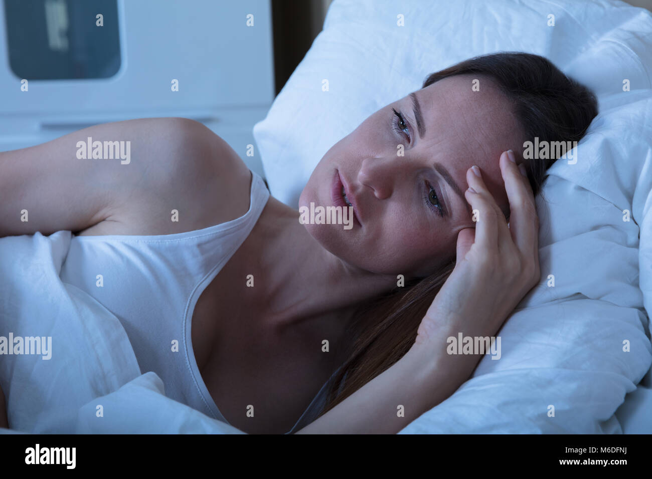 Young Woman Suffering From Insomnia Lying In Her Bed Stock Photo