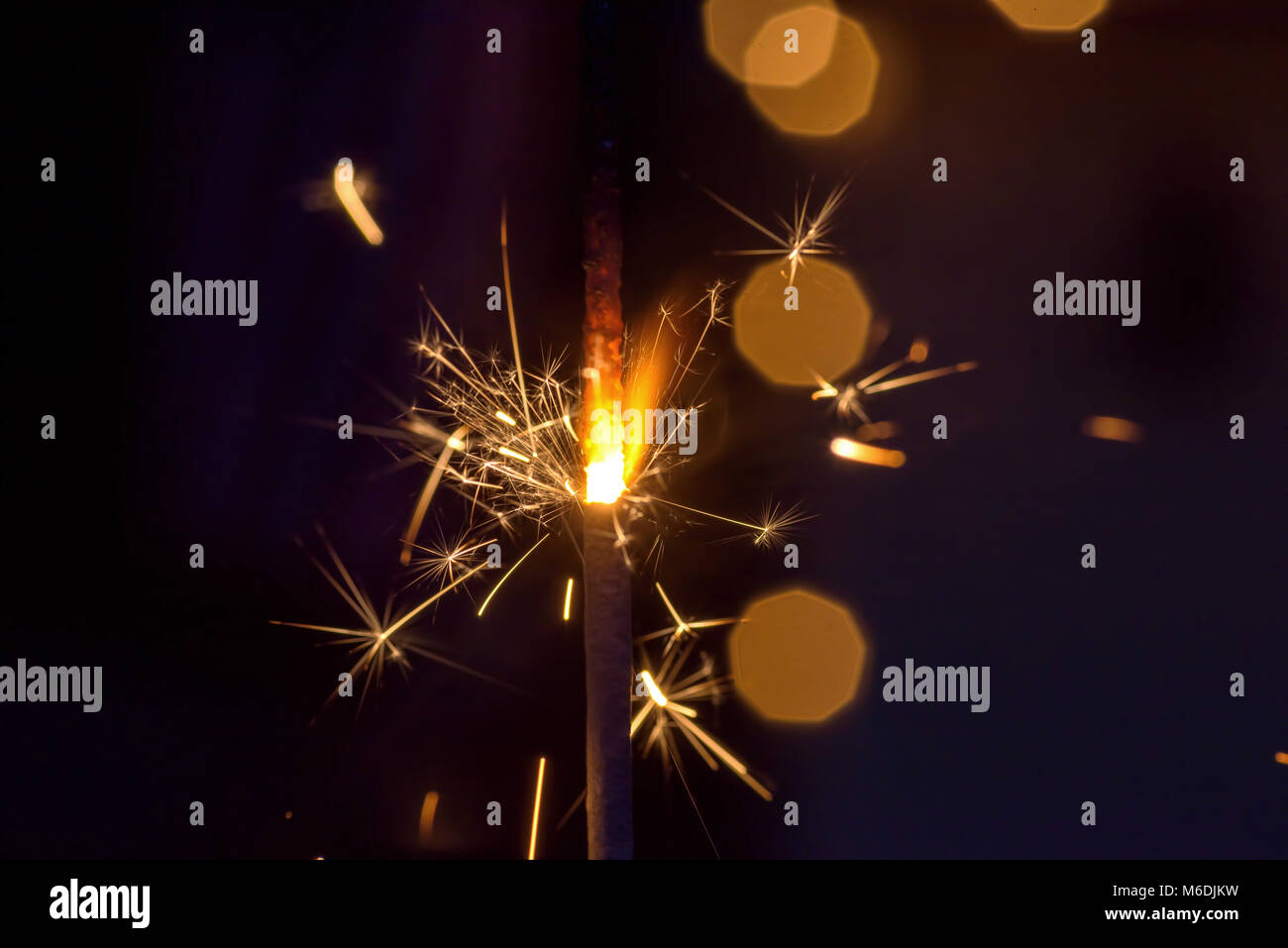 Macro Closeup Of A Single Sparkler Glowing And Shooting Sparks At Night 