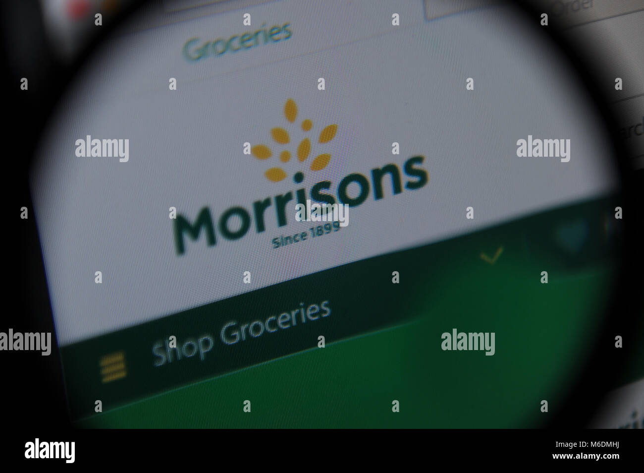 Morrisons website seen through a magnifying glass Stock Photo