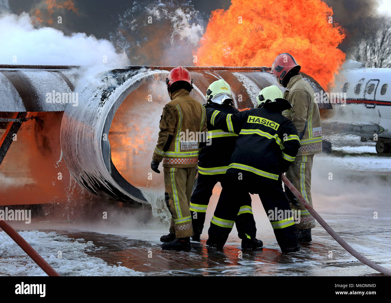 Members of the Slovakian Air Force, (in dark blue), learn how to put ...