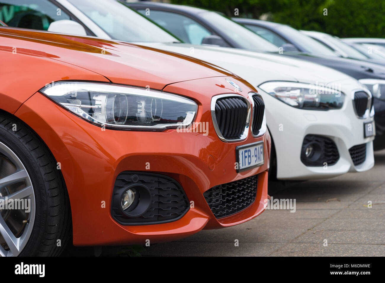 A lineup of brand new BMW cars at the dealership Stock Photo
