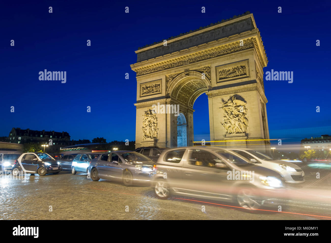 traffic of cars at Arc de Triomphe in Paris city, France. night scene