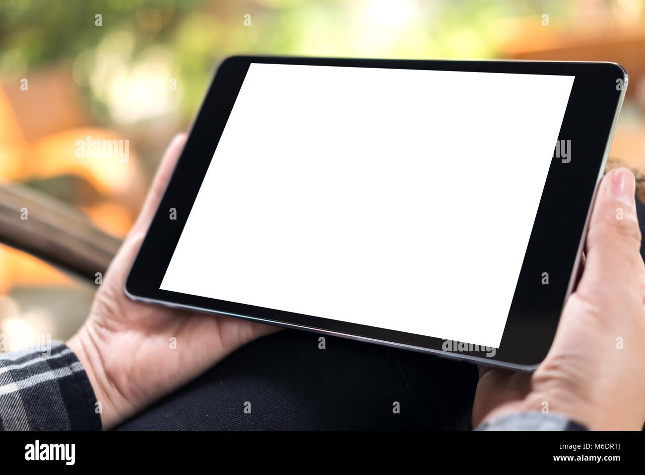 Mockup image of hands holding black tablet pc with blank white screen ...