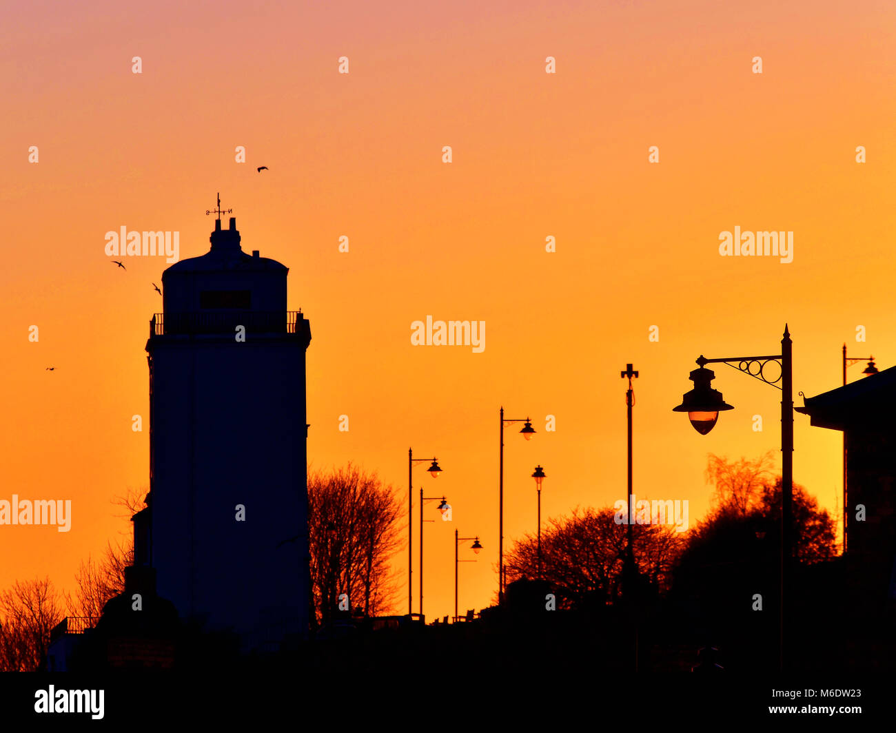 North Shields Highlights lighthouse and street lamps at sunset Stock