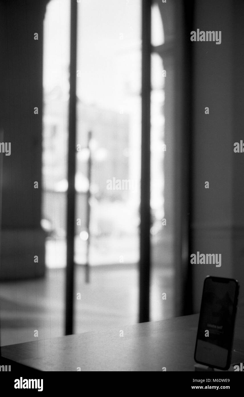 iPhone X placed on the bottom right with a luminous window on the back. Apple Store Piazza della Repubblica, Florence Italy Stock Photo