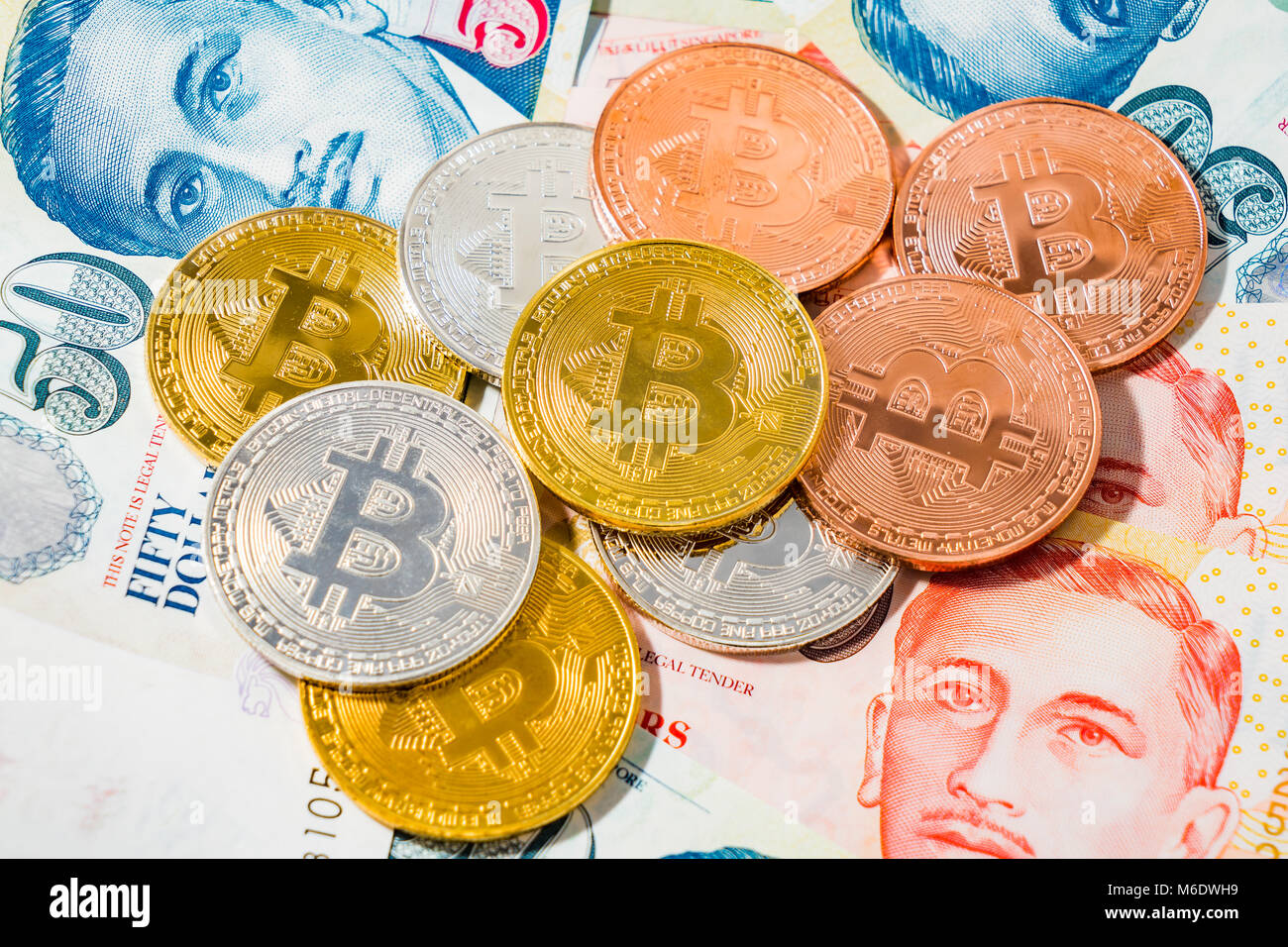 Bitcoin Cryptocurrency coins on top of Singapore Dollar banknotes on White  background, The Singapore dollar is the official currency of Singapore, Con  Stock Photo - Alamy