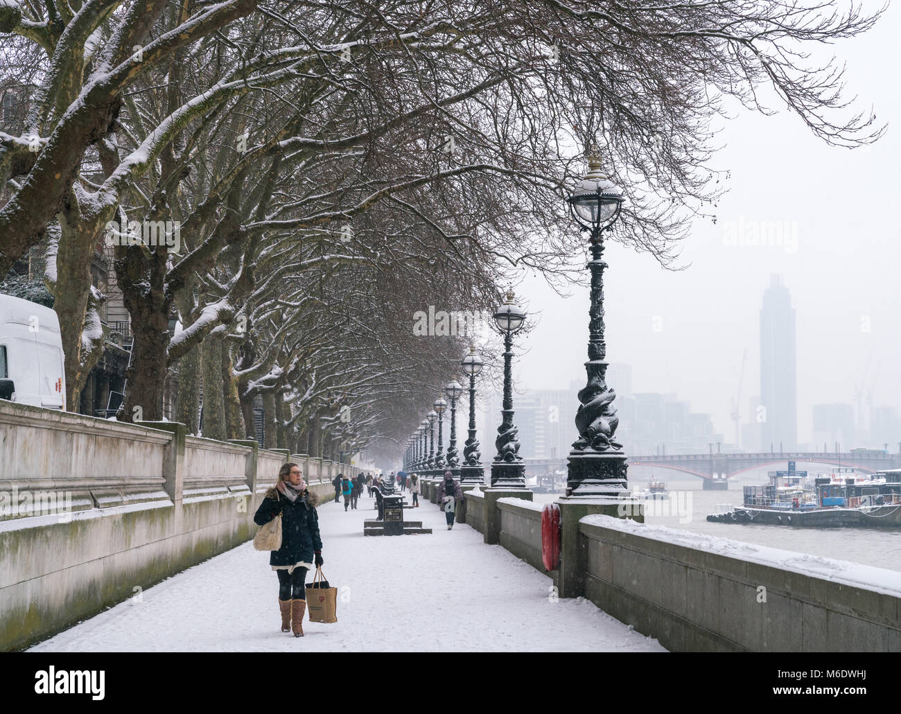 2nd March 2018 - England, London.  Women walking on snow. Snowfall in the capital covered roads and buildings on the second day of spring. Stock Photo
