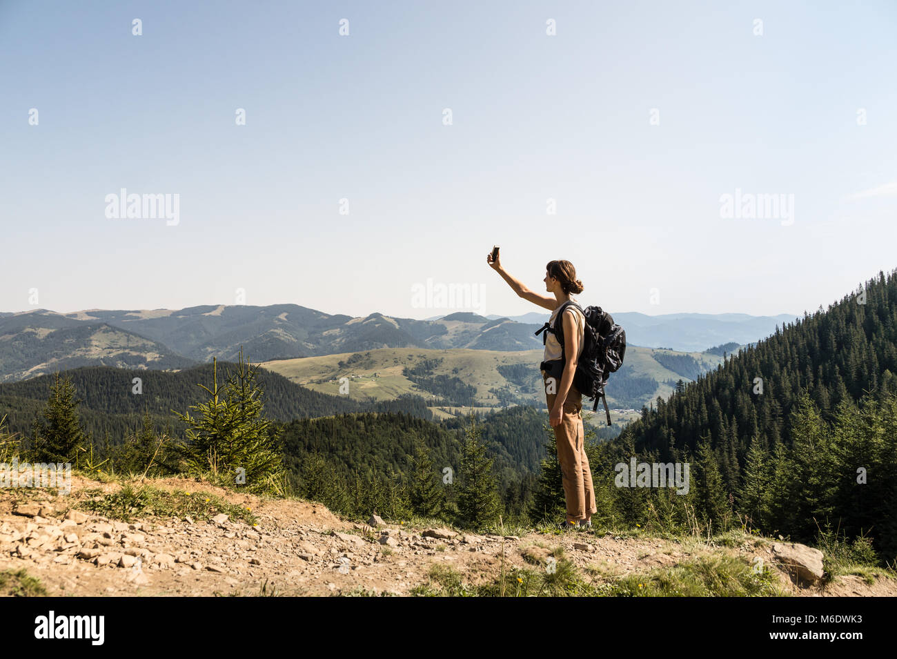 Walk With Rucksack Girl with tourist rucksack on a long hiking walk looking for cell phone ...