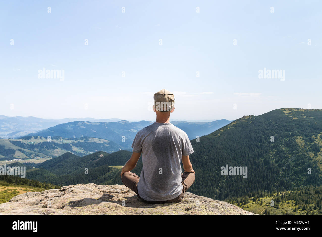 young tourist enjoys gorgeous landscape scenery on hot sunny day Stock Photo
