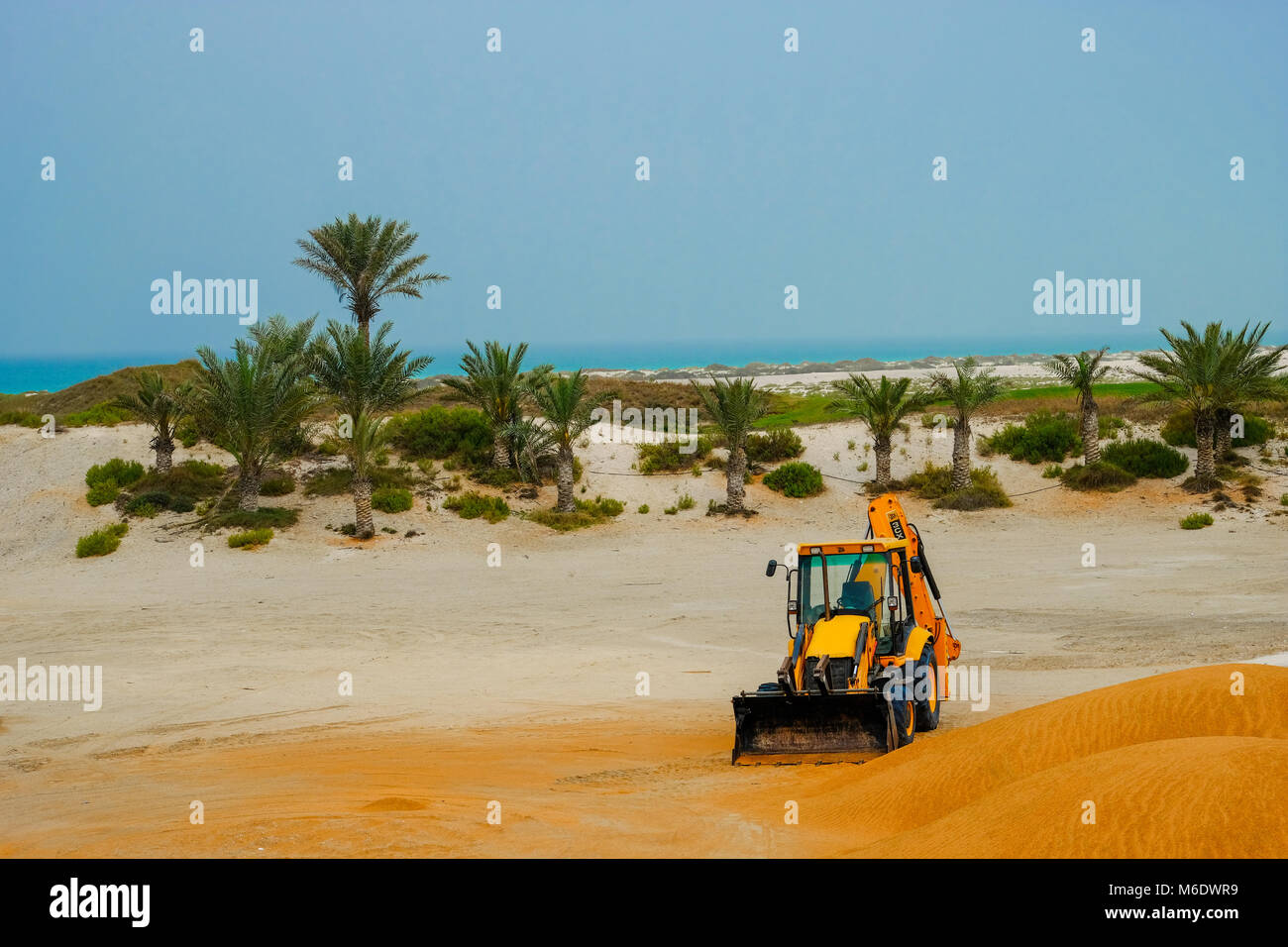 JCB Backhoe Construction Equipment abandoned in Desert area near Saadiyat Island Abu Dhabi Stock Photo