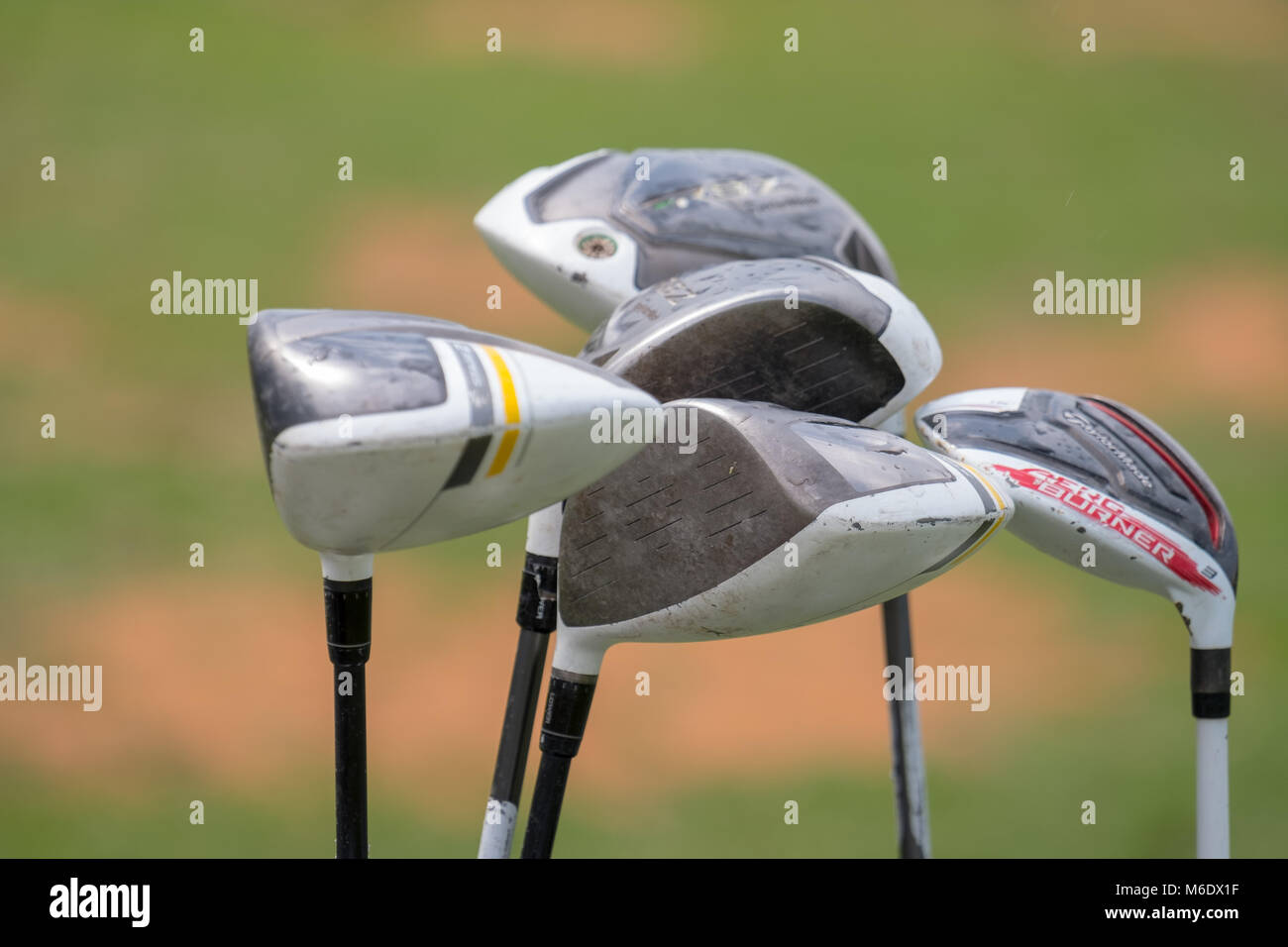 Details of Golf Clubs / Golf iron isolated against golf course Stock Photo