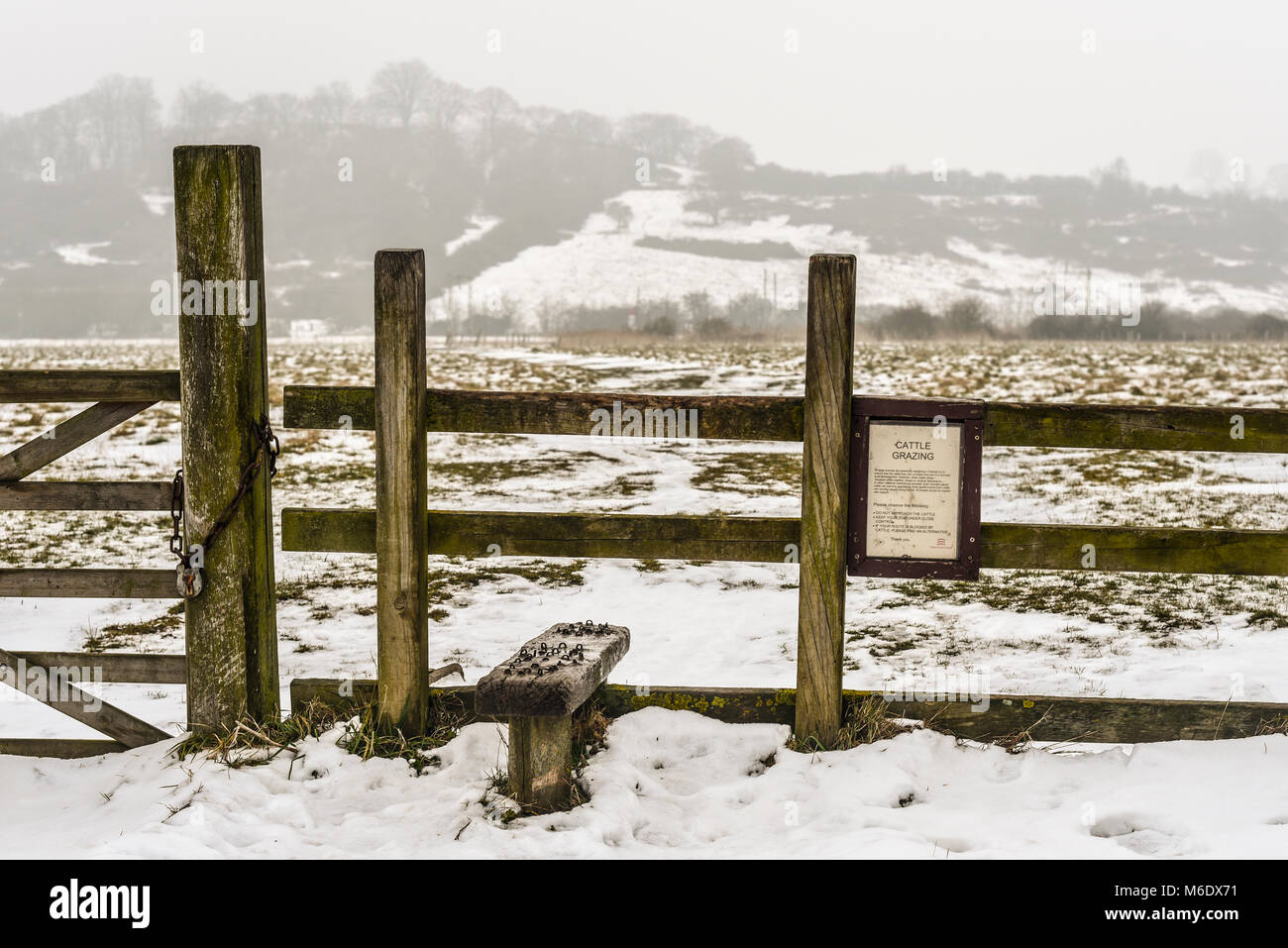 Stile Hadleigh Marsh country park and public footpath in Essex with snow on the ground from the beast from the east weather phenomenon Stock Photo