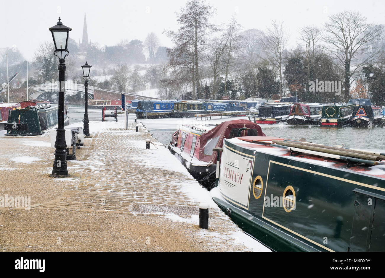 Canal boats in the snow in braunston marina in winter. The Wharf, Braunston, Northamptonshire, UK Stock Photo