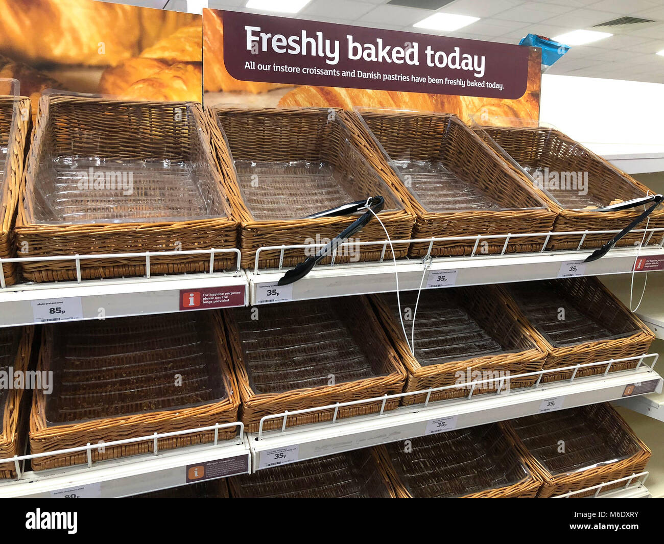 Empty shelves in the baked goods section of a Sainsbury's Local in