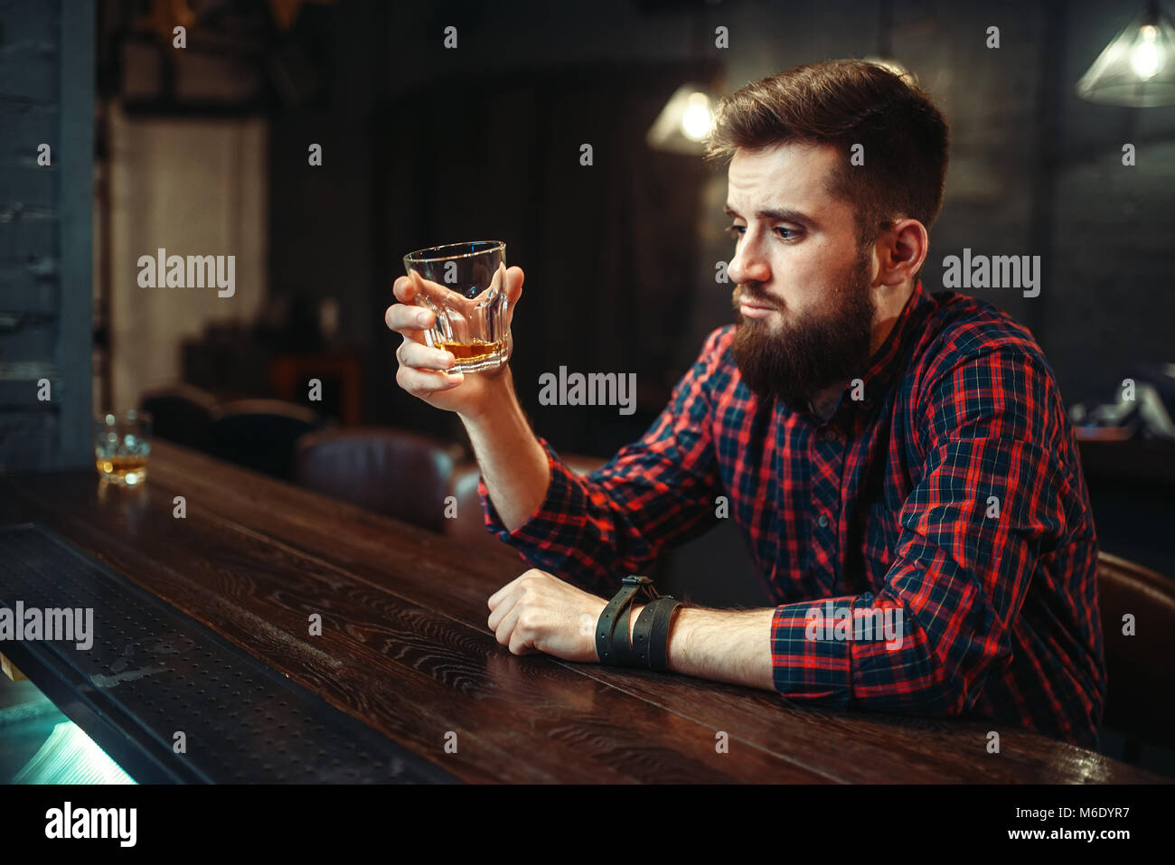 One man sitting at the bar counter and drink alcohol beverage. Male