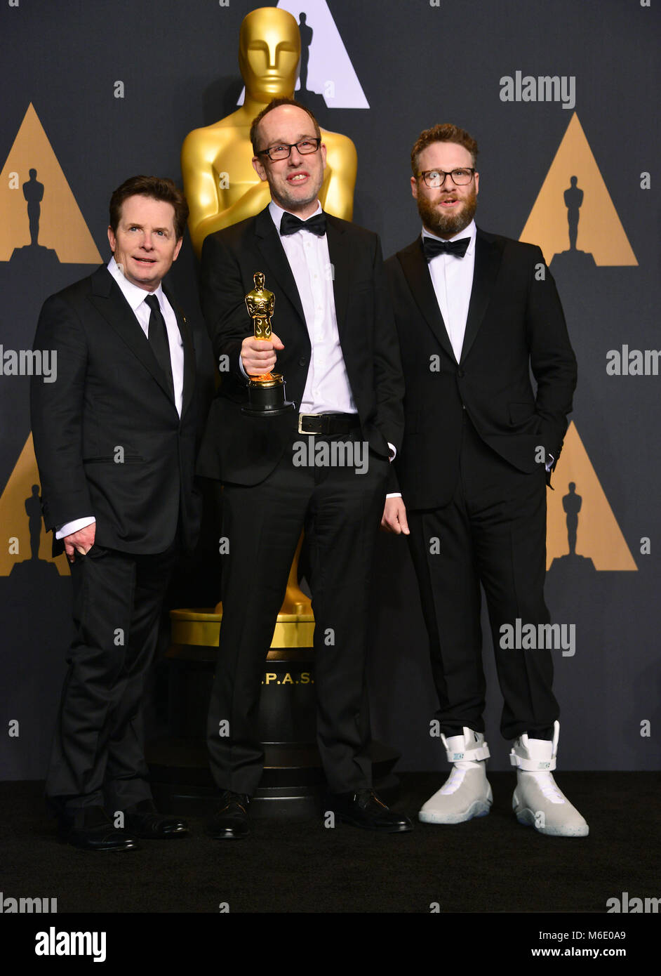 Michael J Fox, John Gilbert, Seth Rogen 432 89th Academy Awards ( Oscars ),  press room at the Dolby Theatre in Los Angeles. February 26, 2017.Michael J  Fox, John Gilbert, Seth Rogen