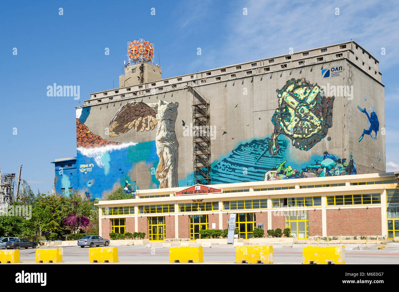 Port of Piraeus, Greece - Mai 30, 2017: Wall painting on one of the old  silo and dry docks  buildings in the industrial area of Silos Ietioneias Coas Stock Photo