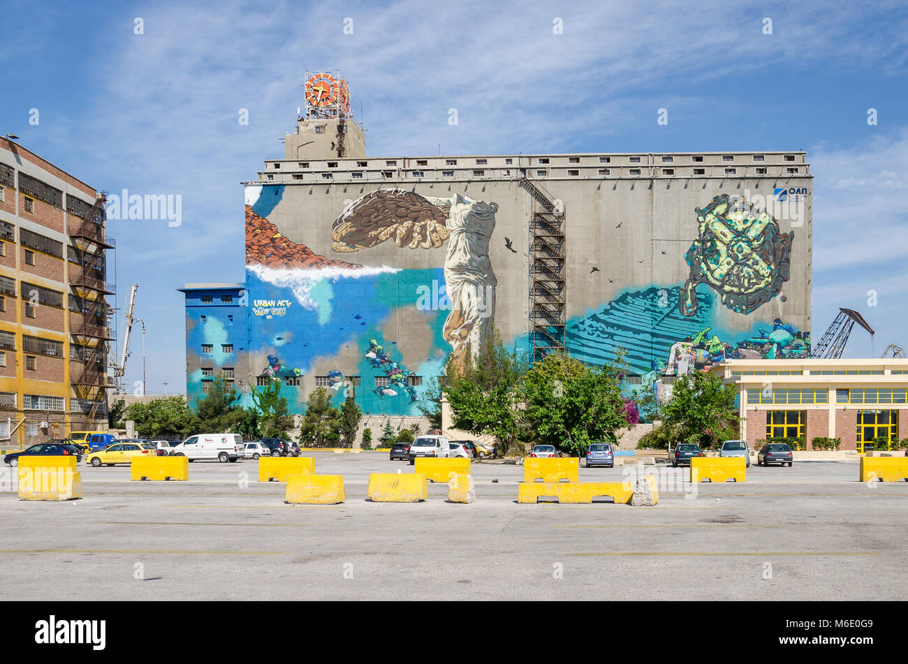 Port of Piraeus, Greece - Mai 30, 2017: Wall painting on one of the old  silo and dry docks  buildings in the industrial area of Silos Ietioneias Coas Stock Photo
