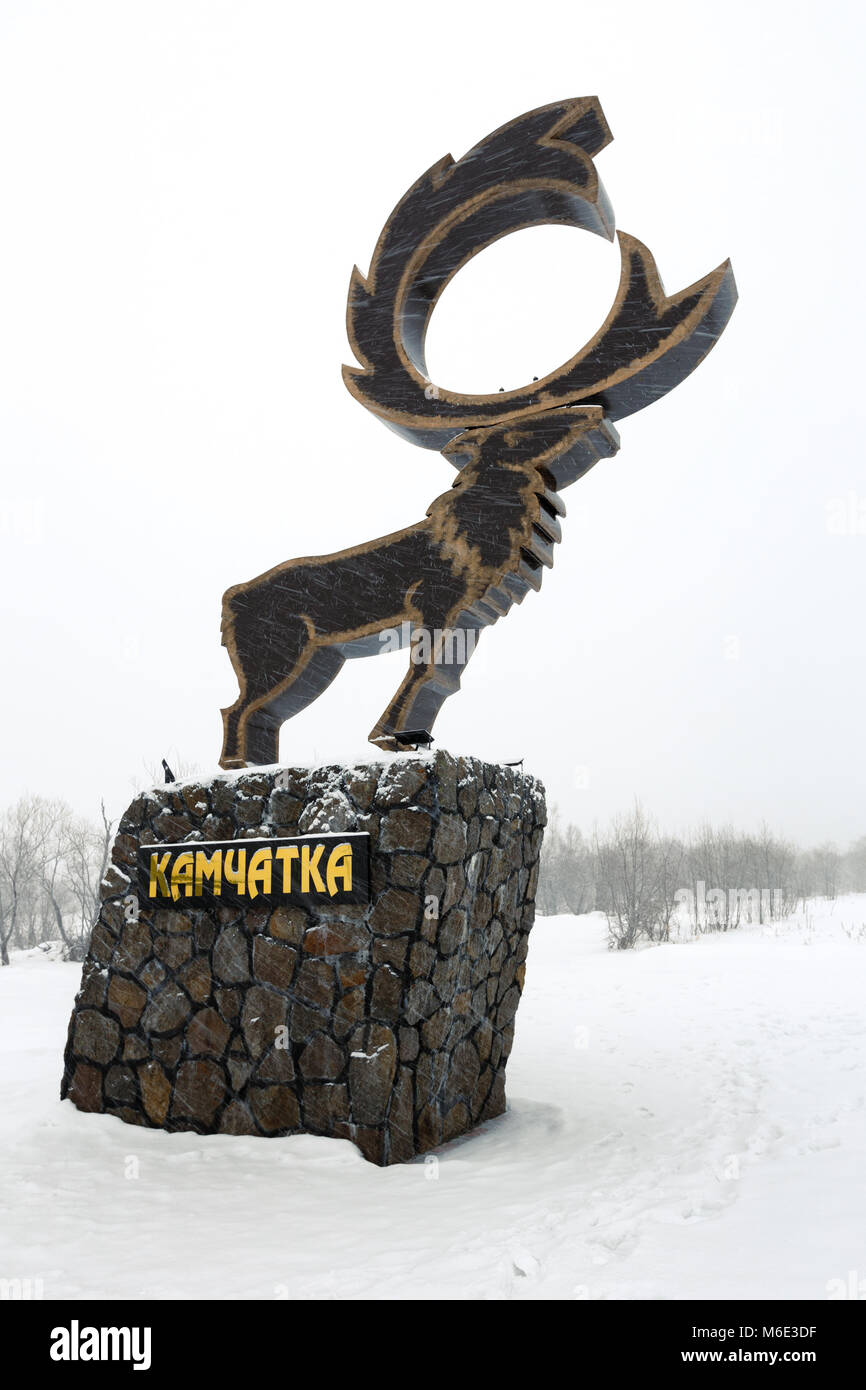 Sculpture wild Kamchatka Reindeer - symbol of Nachiki Village and recreation center Nachiki during the snowstorm. Inscription on pedestal: Kamchatka. Stock Photo