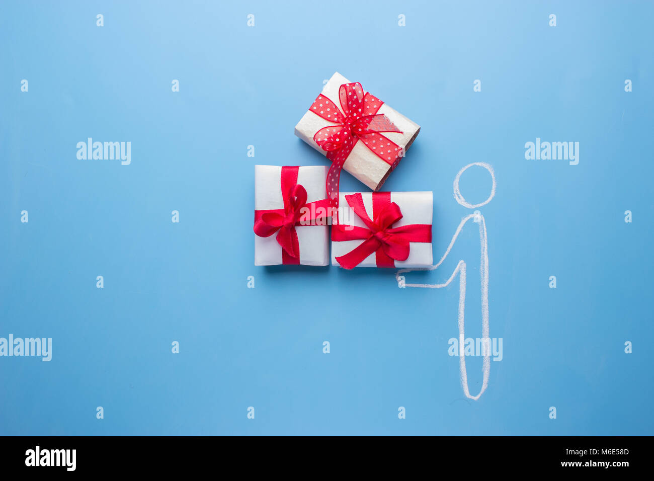 Giving A Box men give a box with red bow with present for women Stock Photo - Alamy