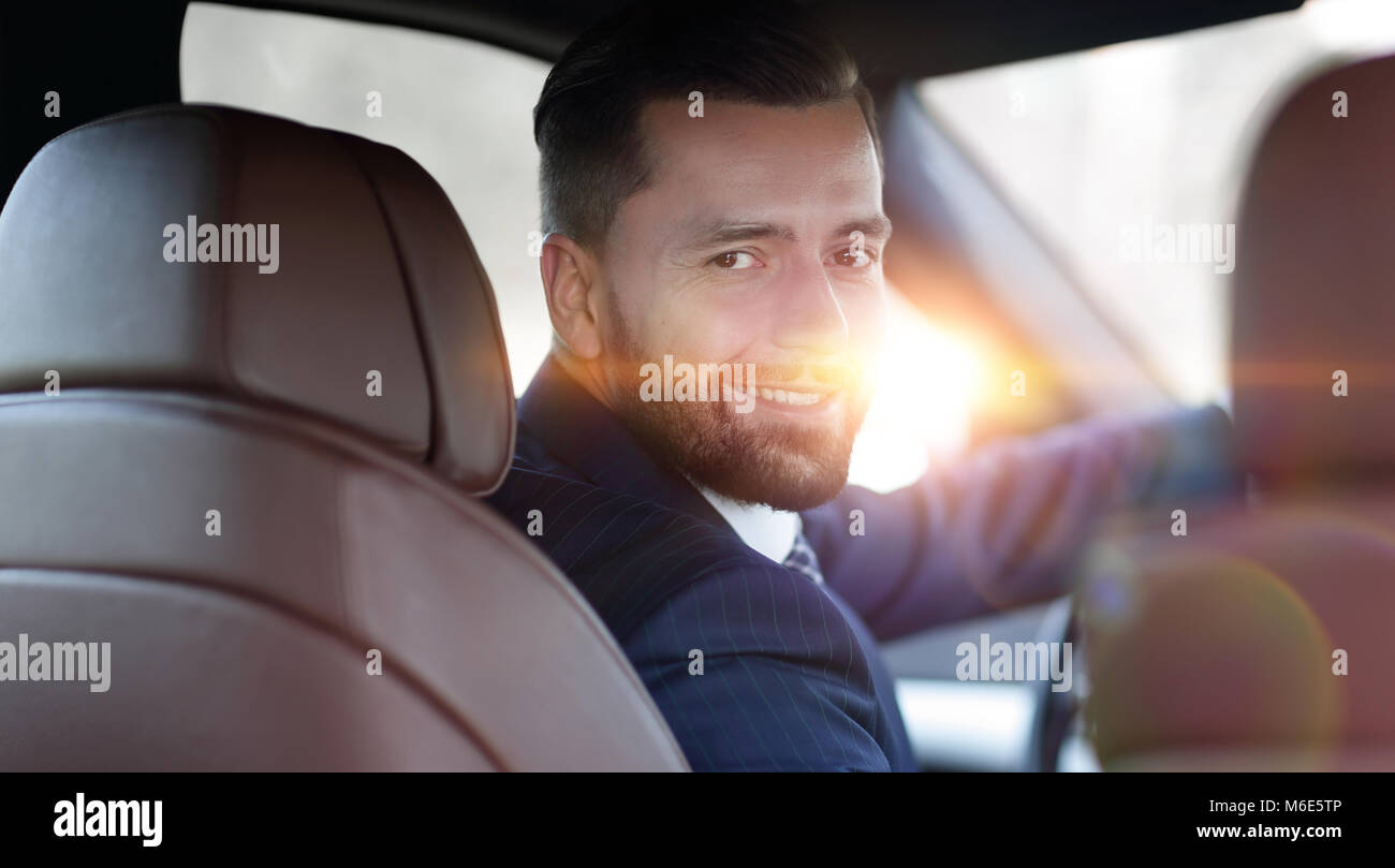 Close-up of a businessman sitting at the wheel of a car Stock Photo - Alamy