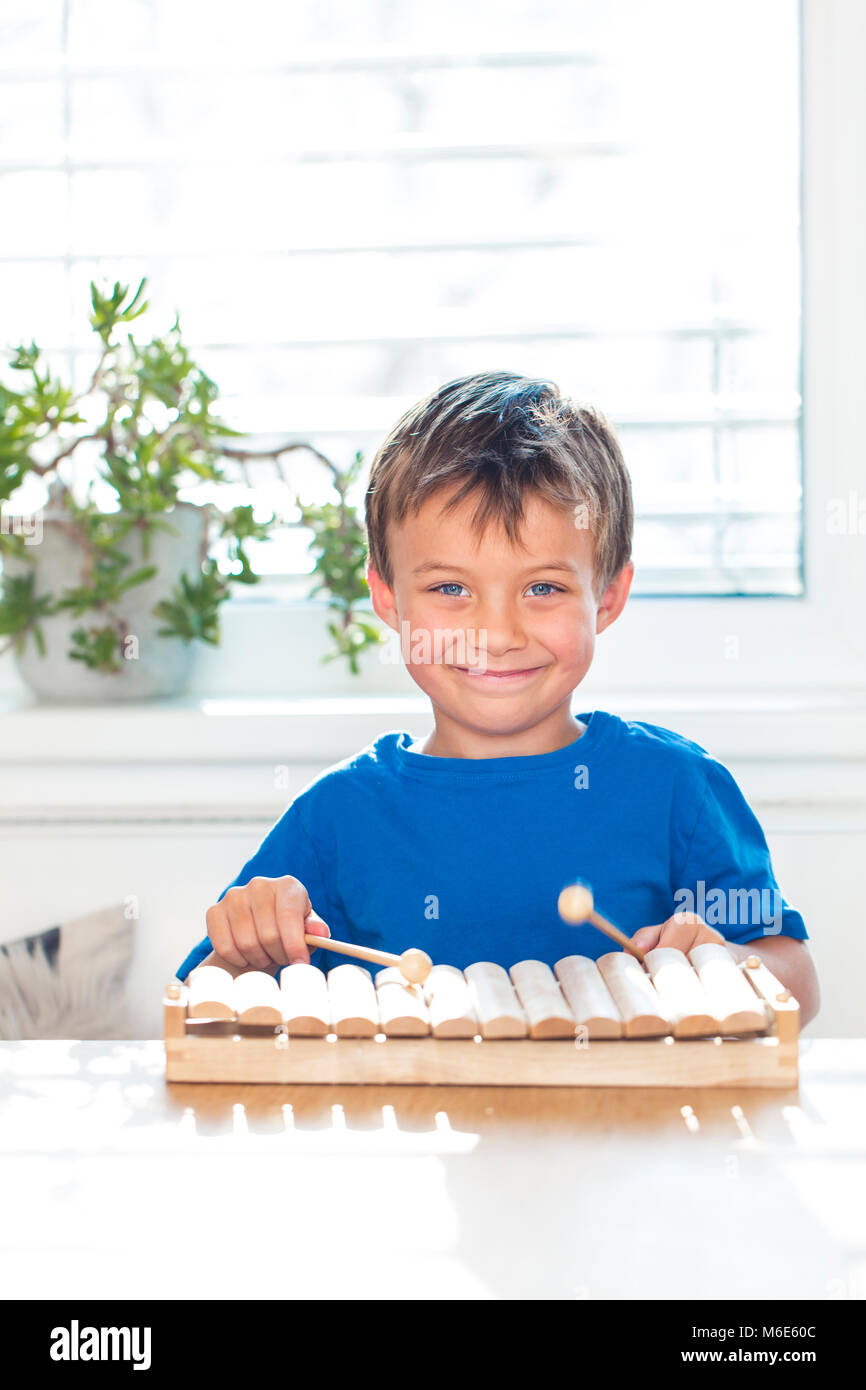 young boy is playing xylophone at home Stock Photo Alamy