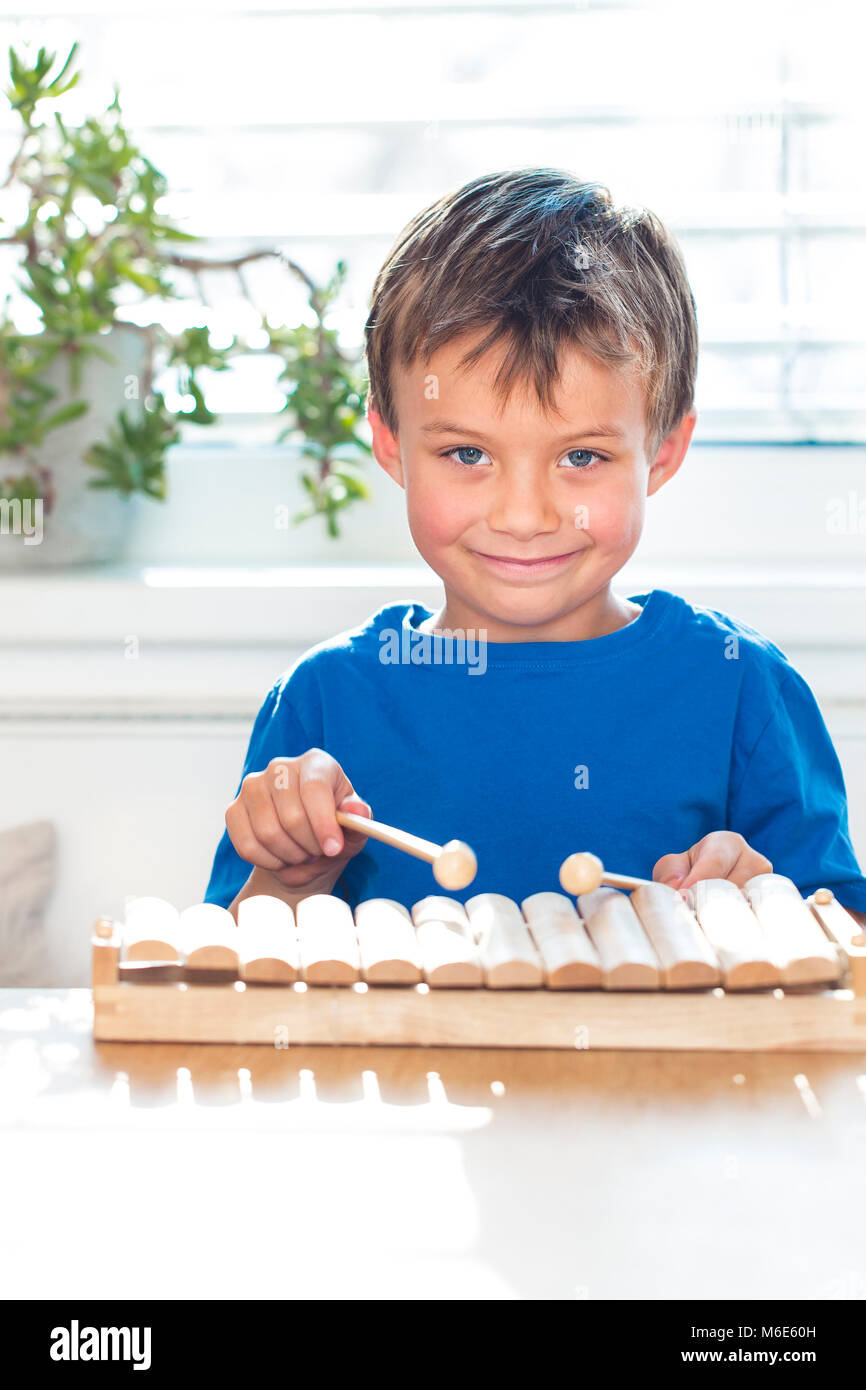 young boy is playing xylophone at home Stock Photo Alamy