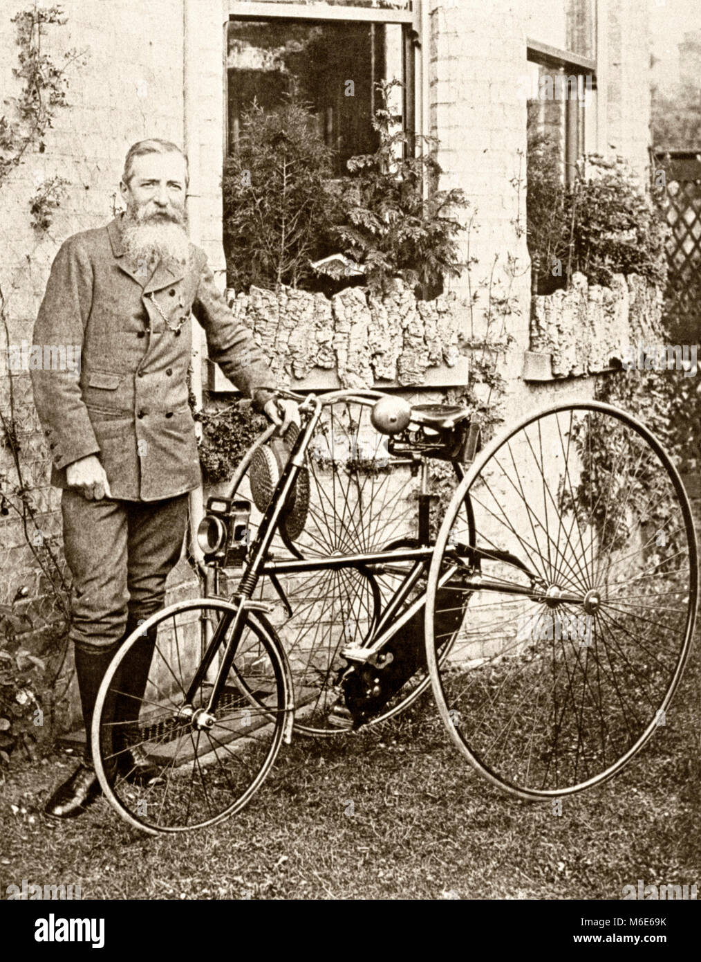 Thomas Humber together with one of his company's tricycles c. 1900. Thomas Humber (1841–1910) was a British engineer and cycle manufacturer and founded Humber Cycles. The three wheeler had two rear large wheels with a much smaller front steering wheel – all had solid rubber tyres Stock Photo