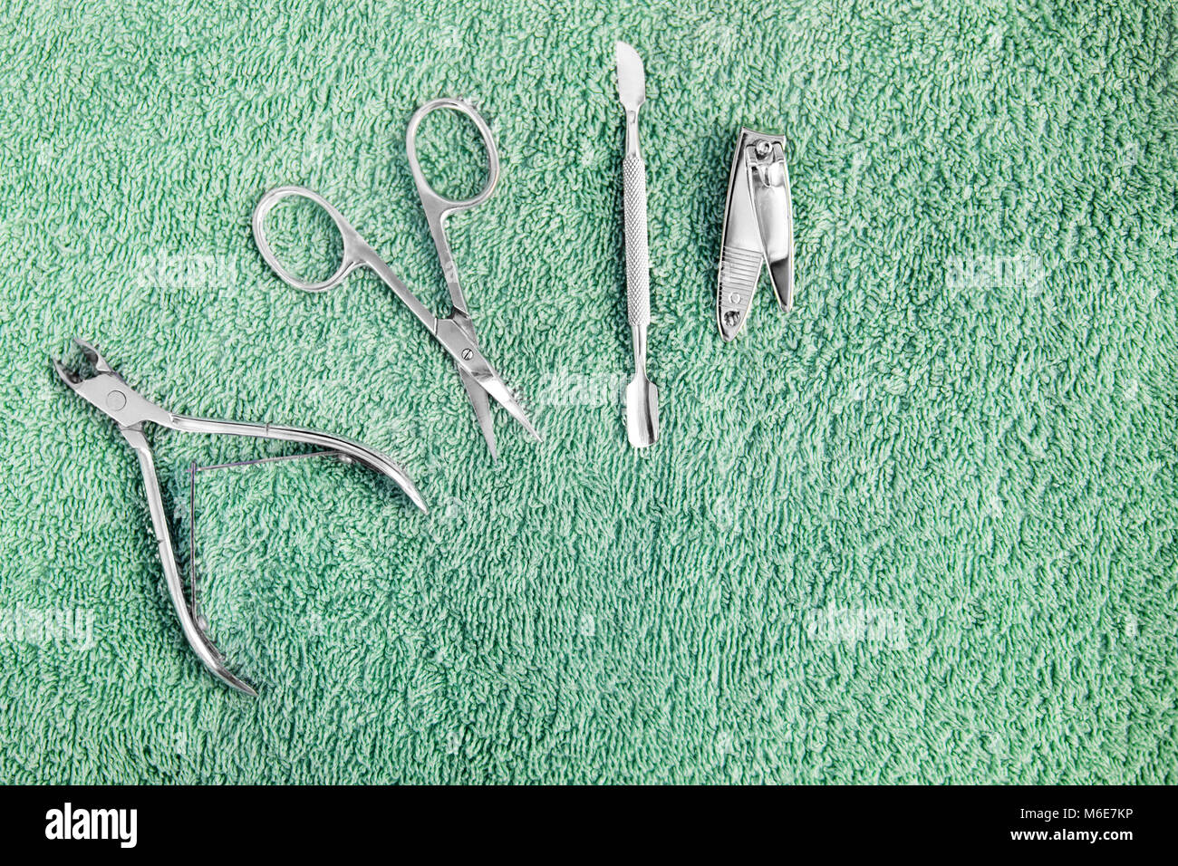 Set of manicure instruments on towel. Nail care, top view Stock Photo