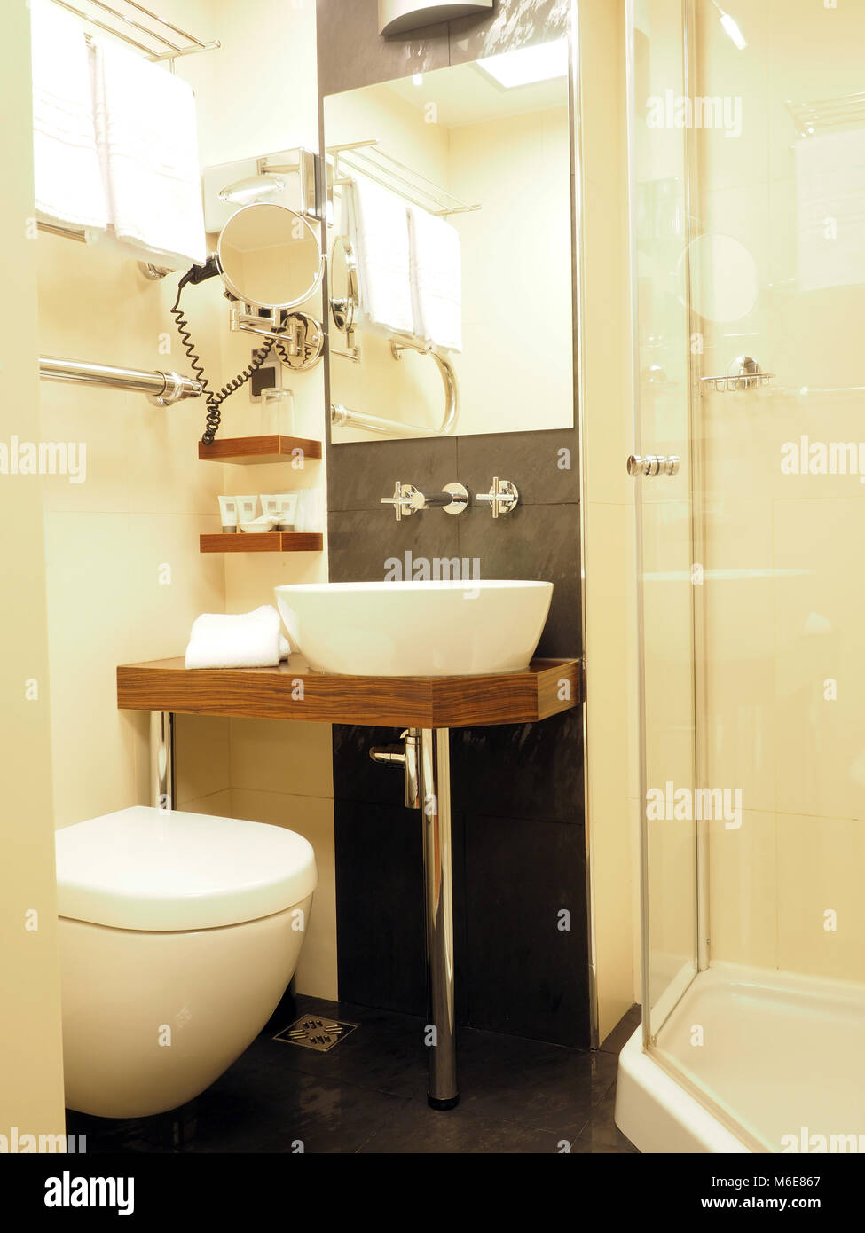 bathroom two star hotel Milan Italy  with shower toilet vanity and sink Stock Photo