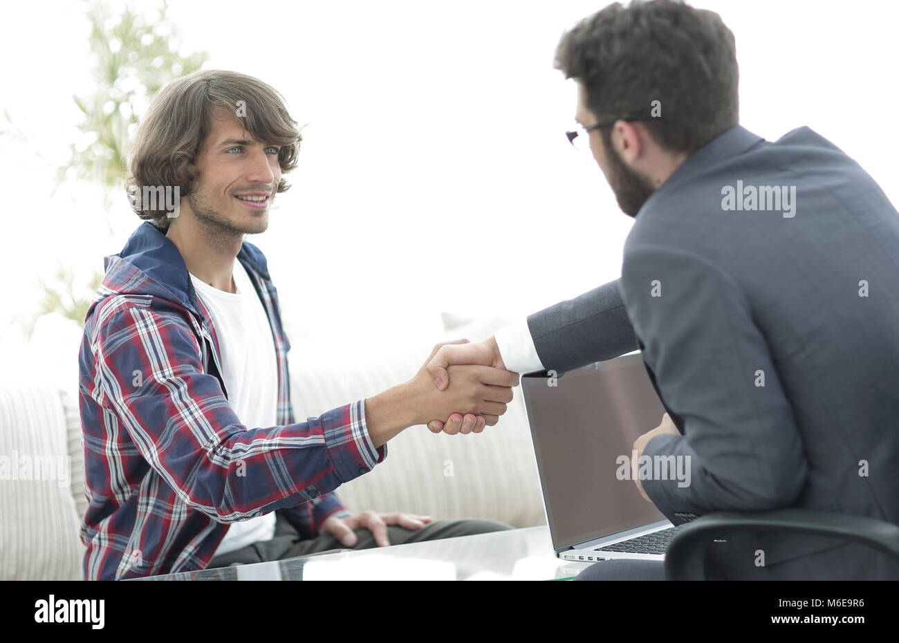 manager shakes hands with his client Stock Photo - Alamy