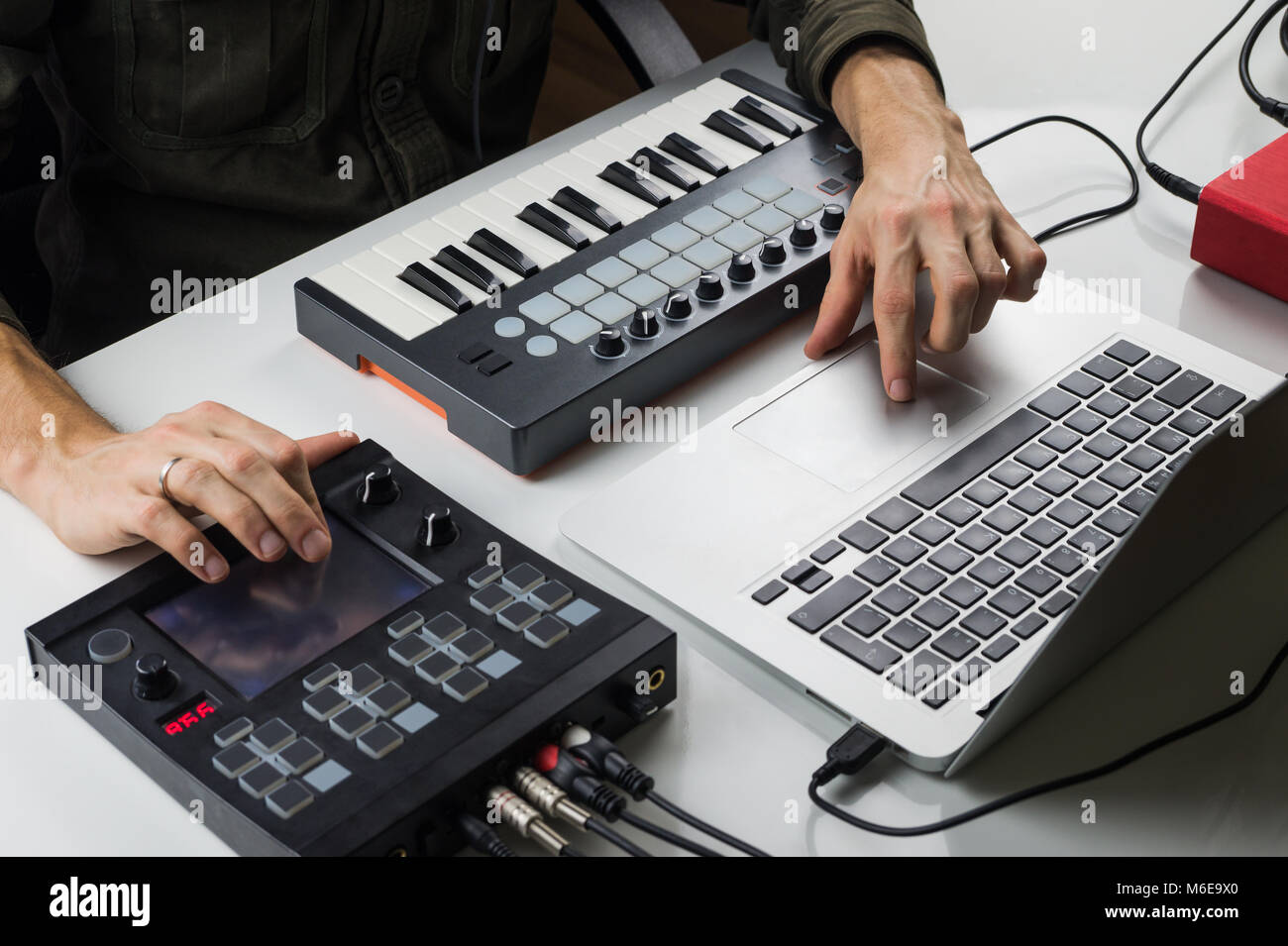 Producing electronic music on laptop with portable midi keyboard and electronic effect processors Stock Photo