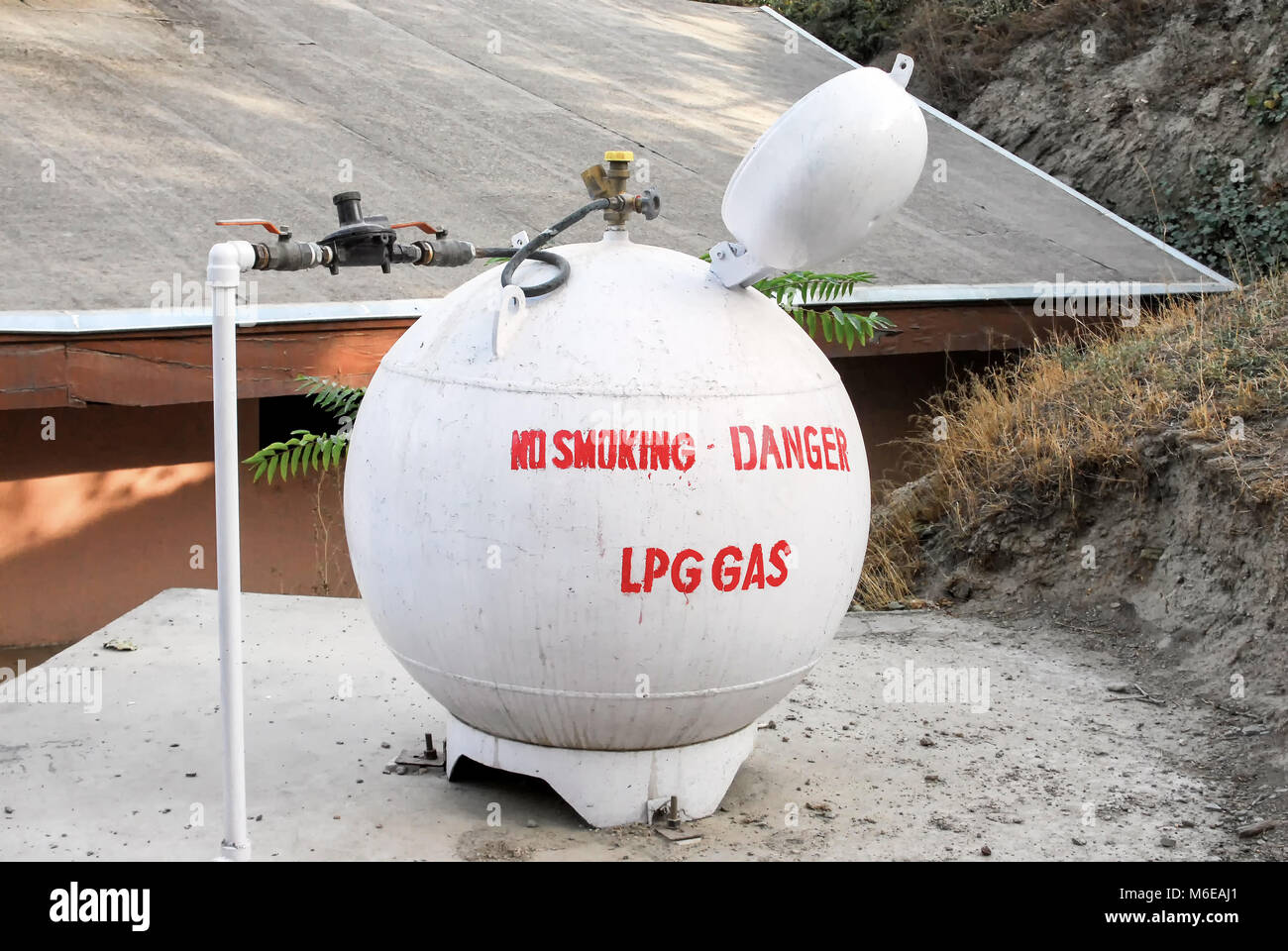 A round LPG gas tank with an unusual design saying no smoking danger