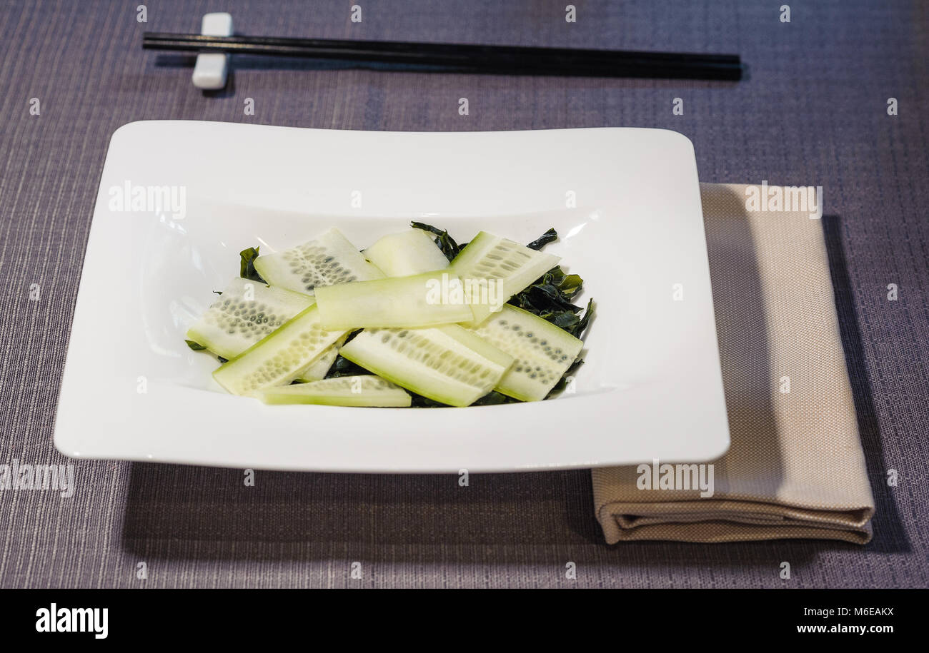algae and cucumber salad seasoned with rice vinegar, served in a