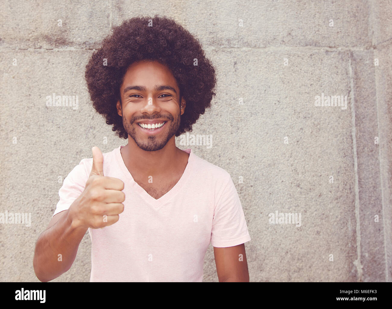 African american hipster man showing thumb up outdoors in vintage retro look Stock Photo