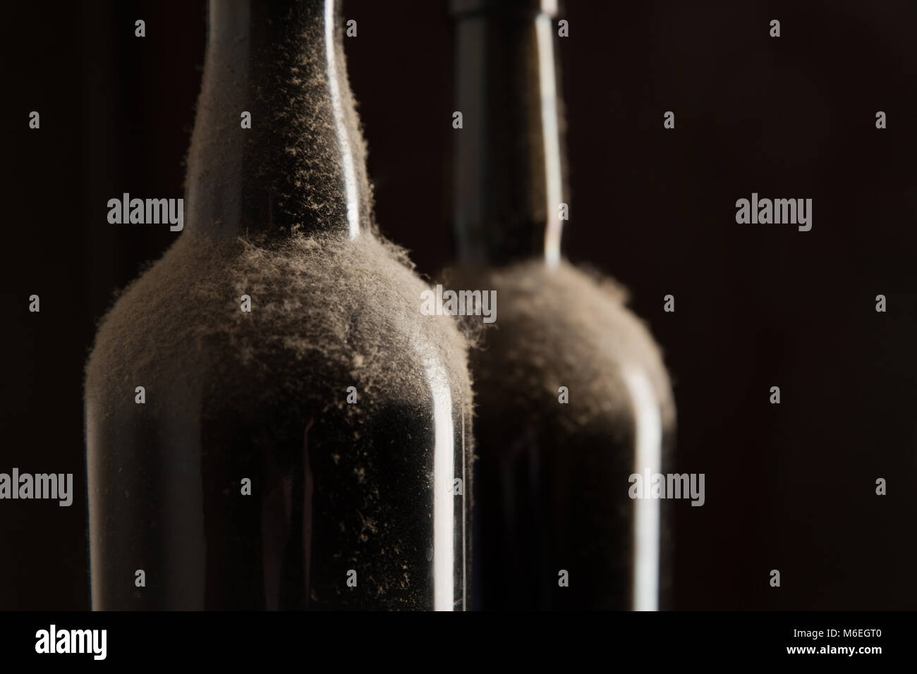 Vintage wine - Dusty bottles over black background Stock Photo