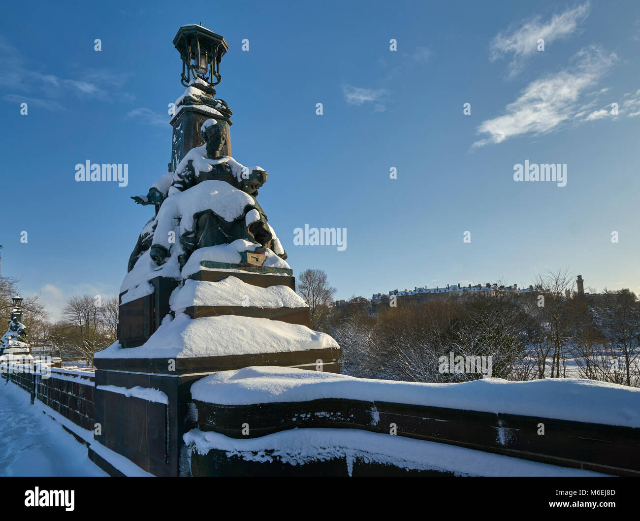Snow covered statues on Kelvin Way Bridge on a sunny day after heavy snow Stock Photo