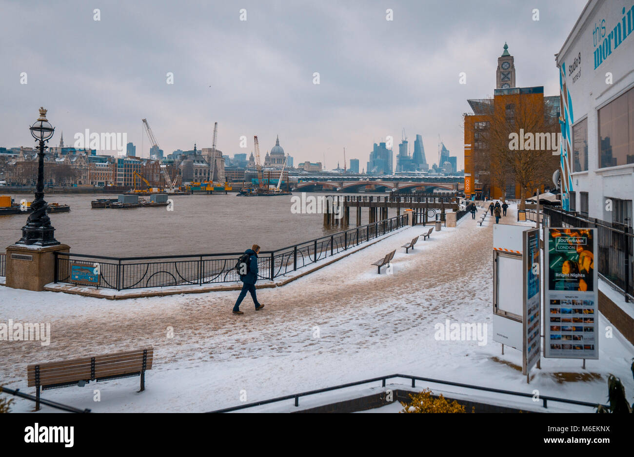 Heavy snowfall covers a footpath along the River Thames, South Bank in London, Britain Stock Photo