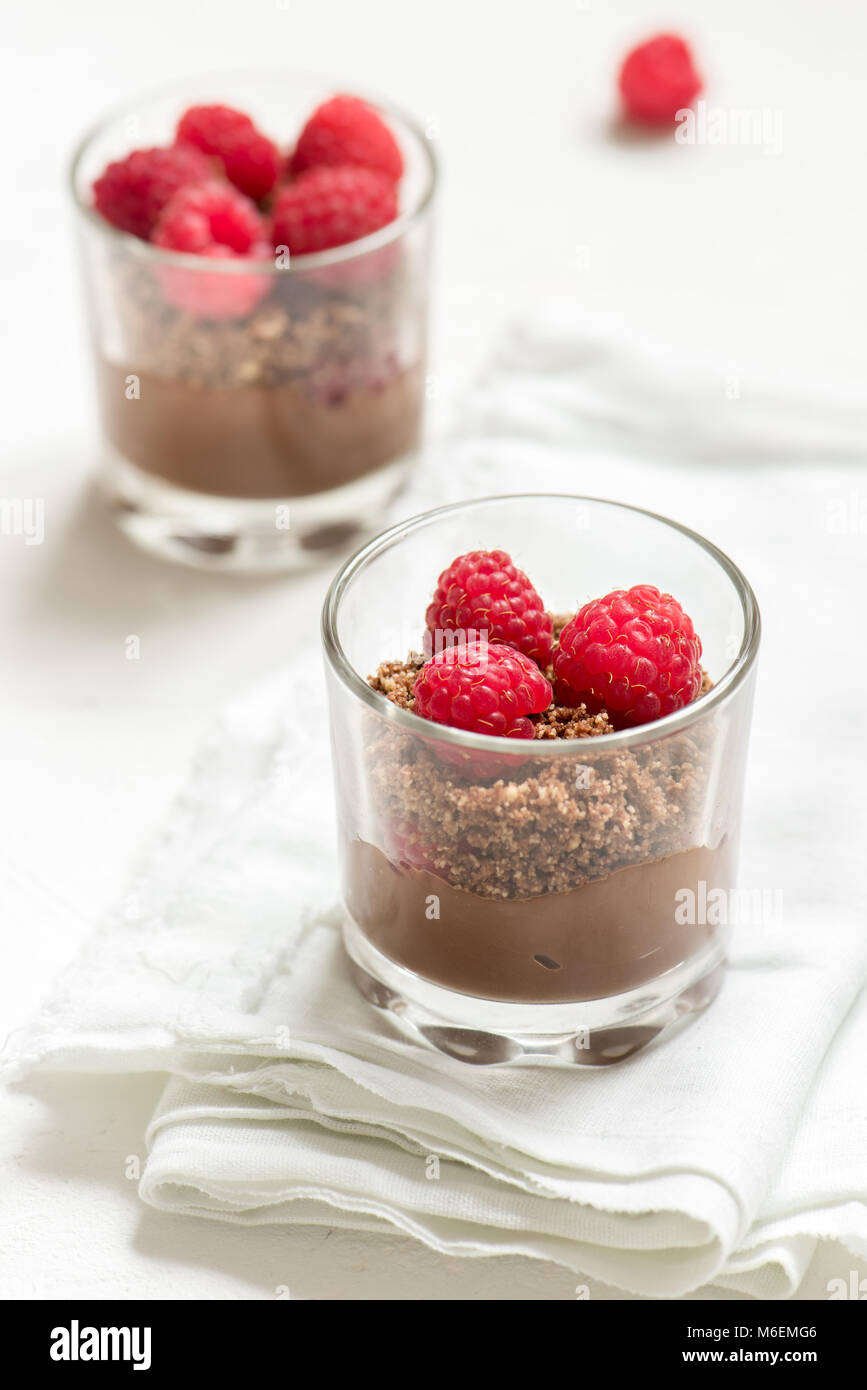 Chocolate dessert in glasses with raspberries. Chocolate mousse or