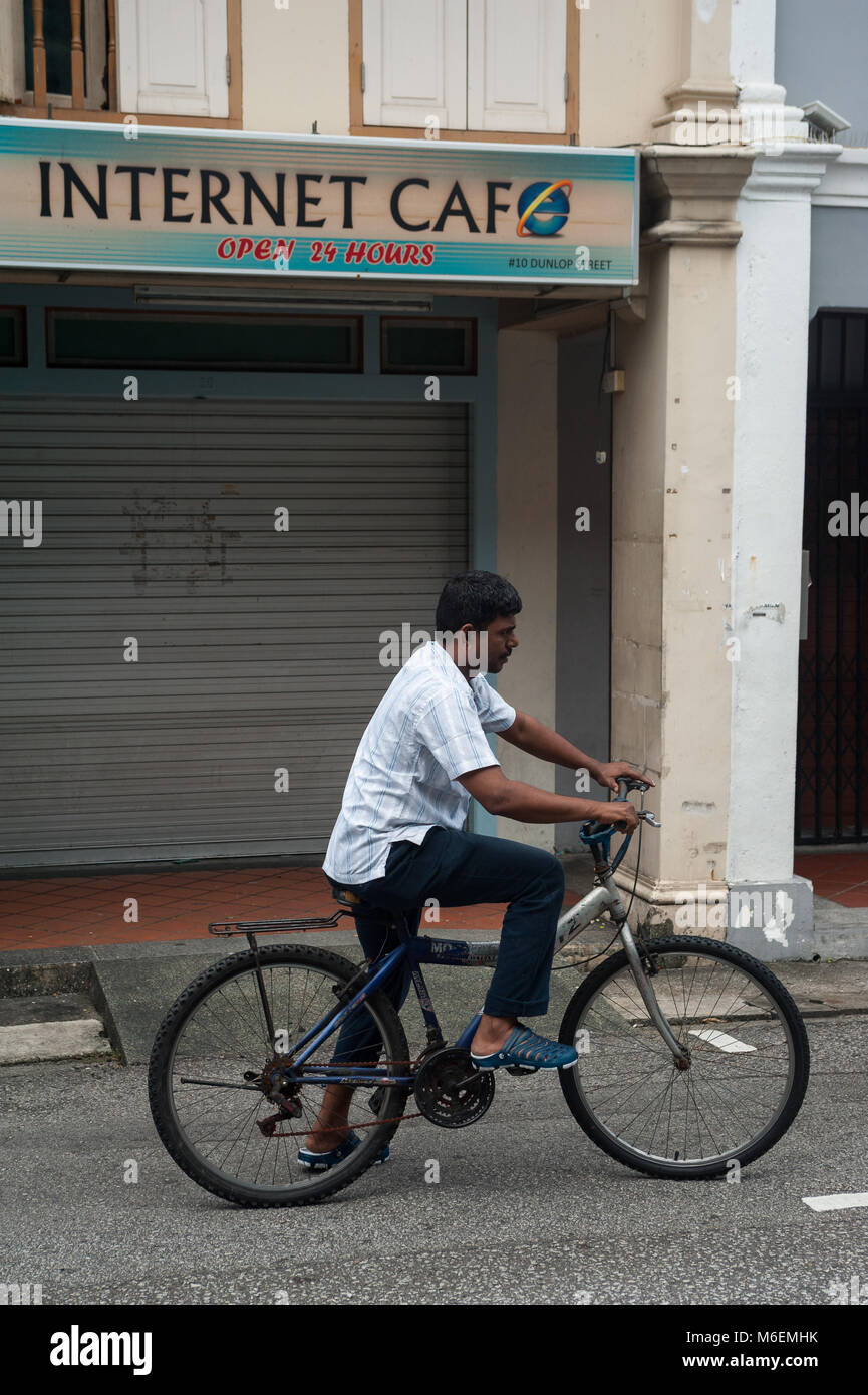 31.01.2018, Singapore, Republic of Singapore, Asia - A bicyclist is seen in front of a closed internet cafe in Singapore's Little India district. Stock Photo