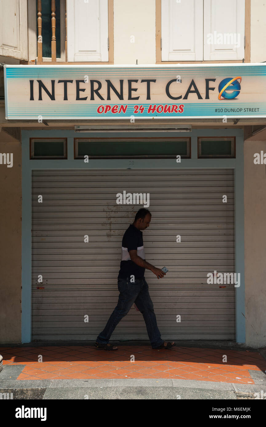 31.01.2018, Singapore, Republic of Singapore, Asia - A man walks by a closed internet cafe in Singapore's Little India district. Stock Photo