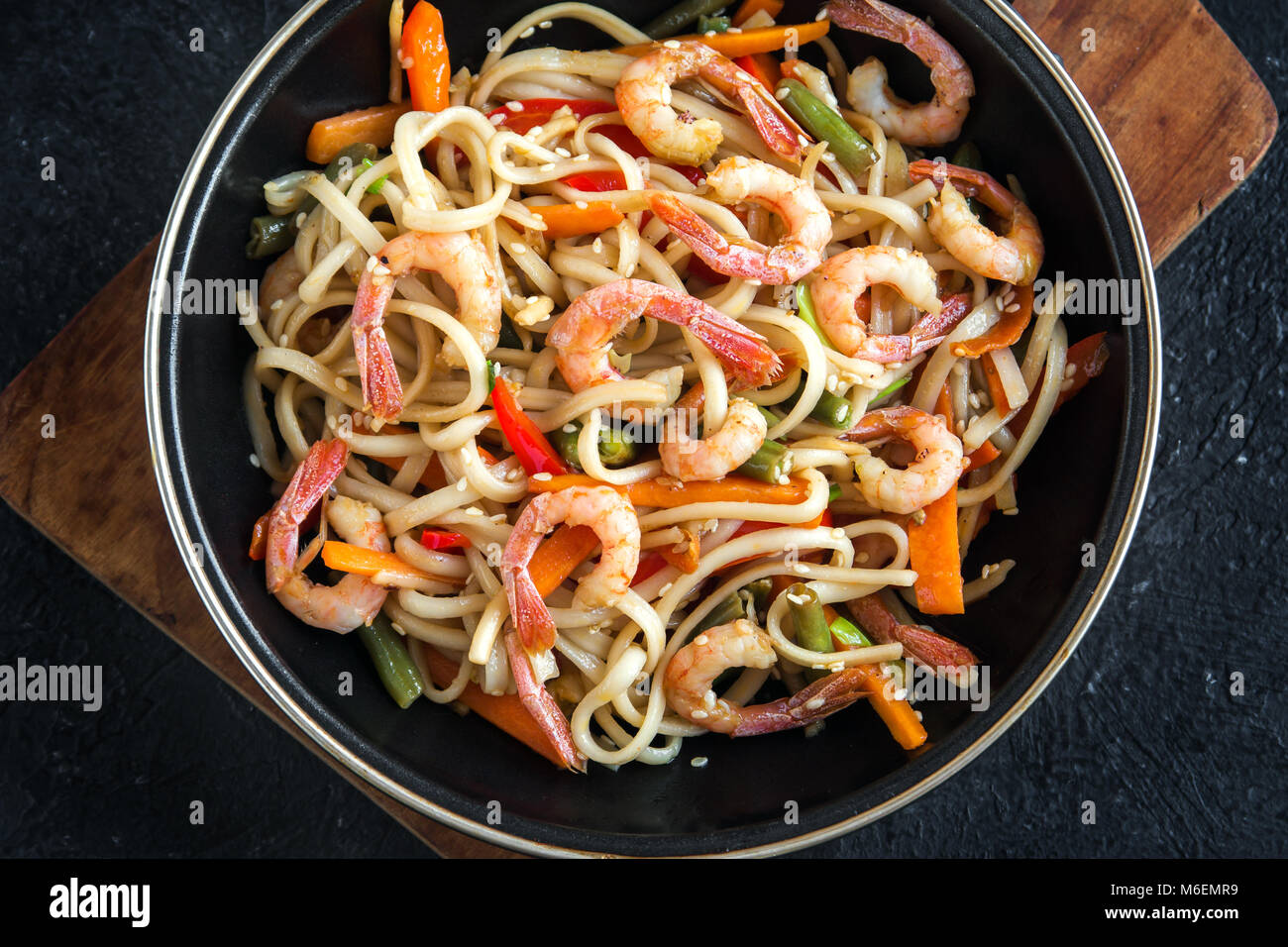 Stir fry with udon noodles, shrimps (prawns) and vegetables. Asian
