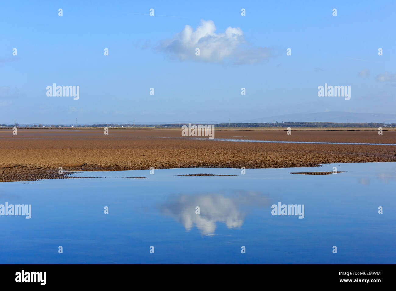 View of cloud reflections on the Solway Estuary shore line Scotland Stock Photo