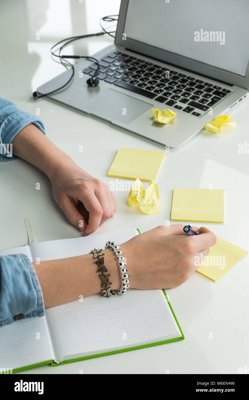 Female hands writing ideas on paper Stock Photo - Alamy