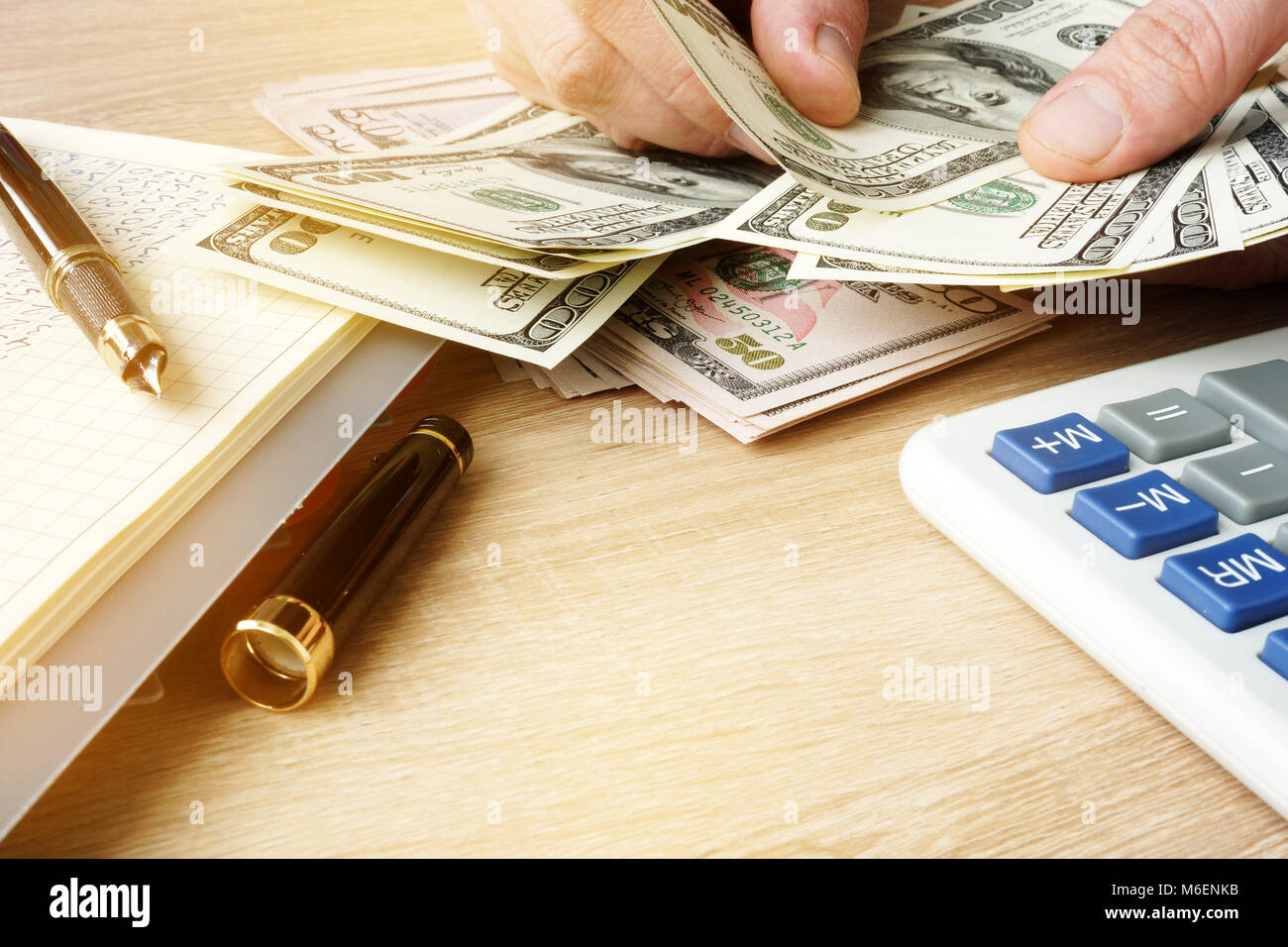Hands counting money. Home budget. US dollars bills. Stock Photo