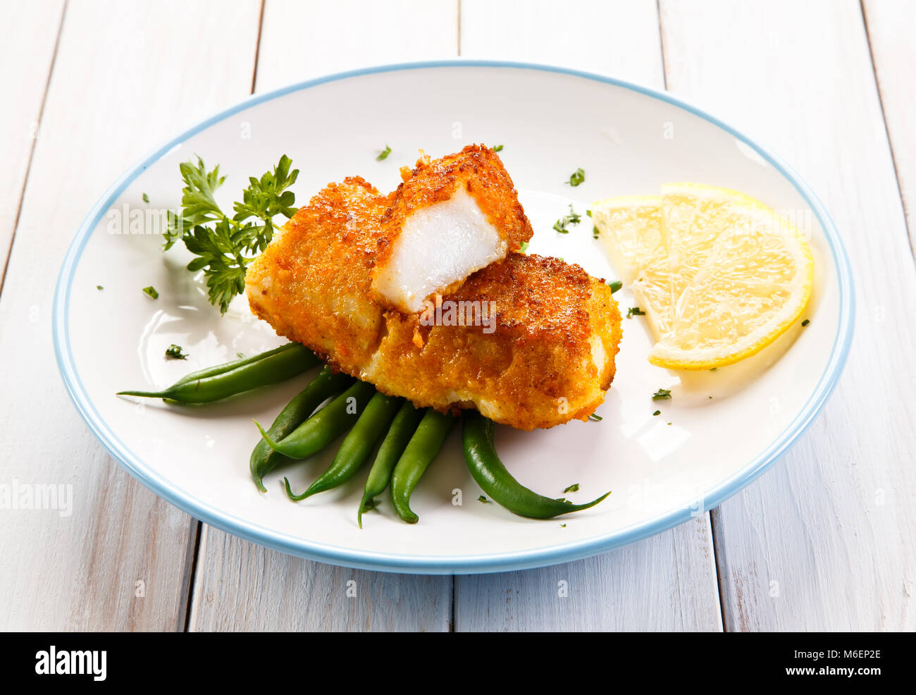 Fish dish - fried fish fillets and vegetables Stock Photo