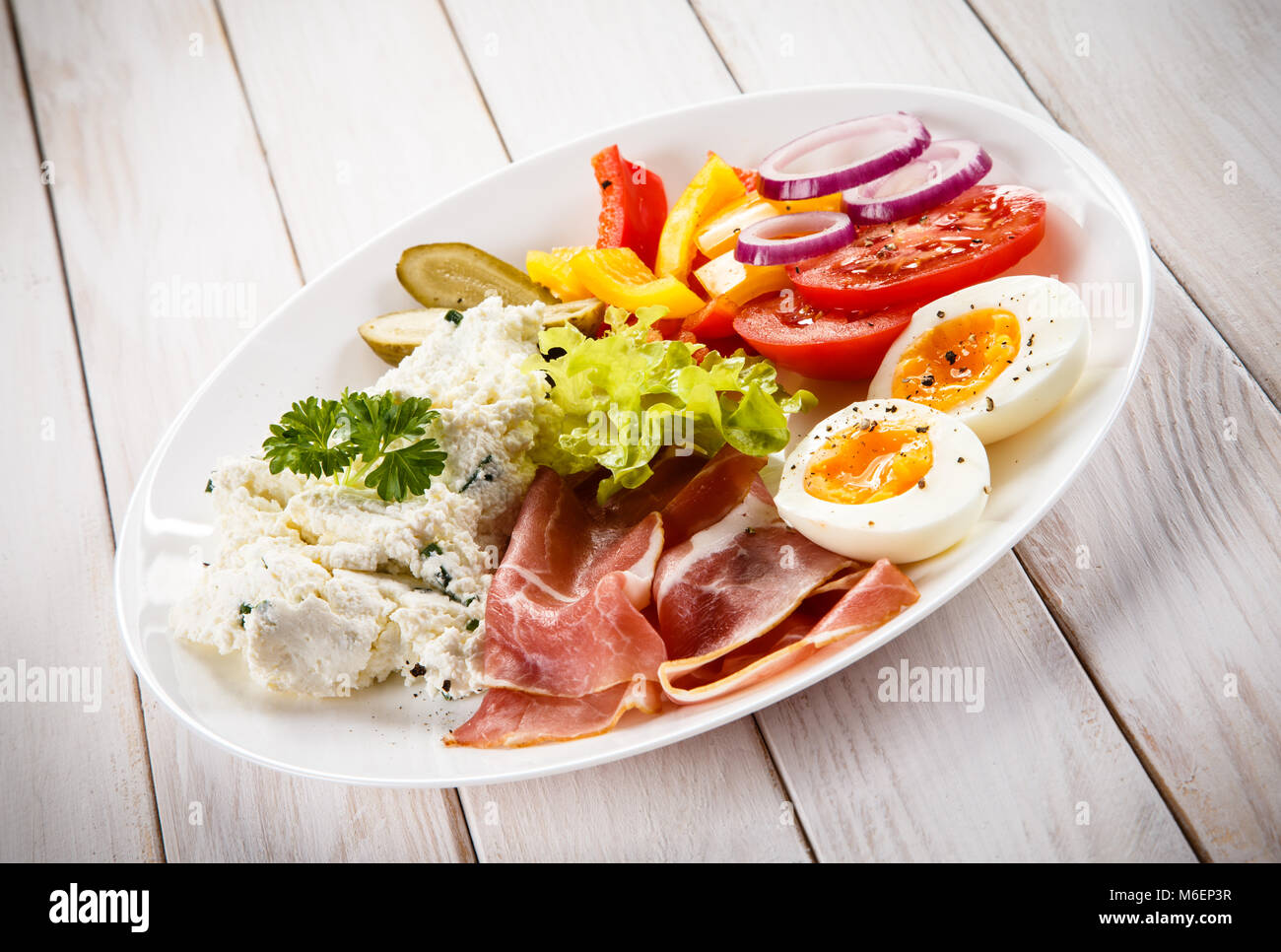 Breakfast boiled egg, bacon, cottage cheese and vegetables Stock