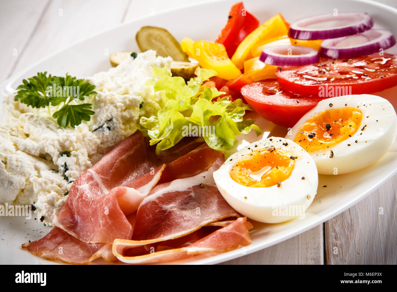 Breakfast - boiled egg, bacon, cottage cheese and vegetables Stock Photo