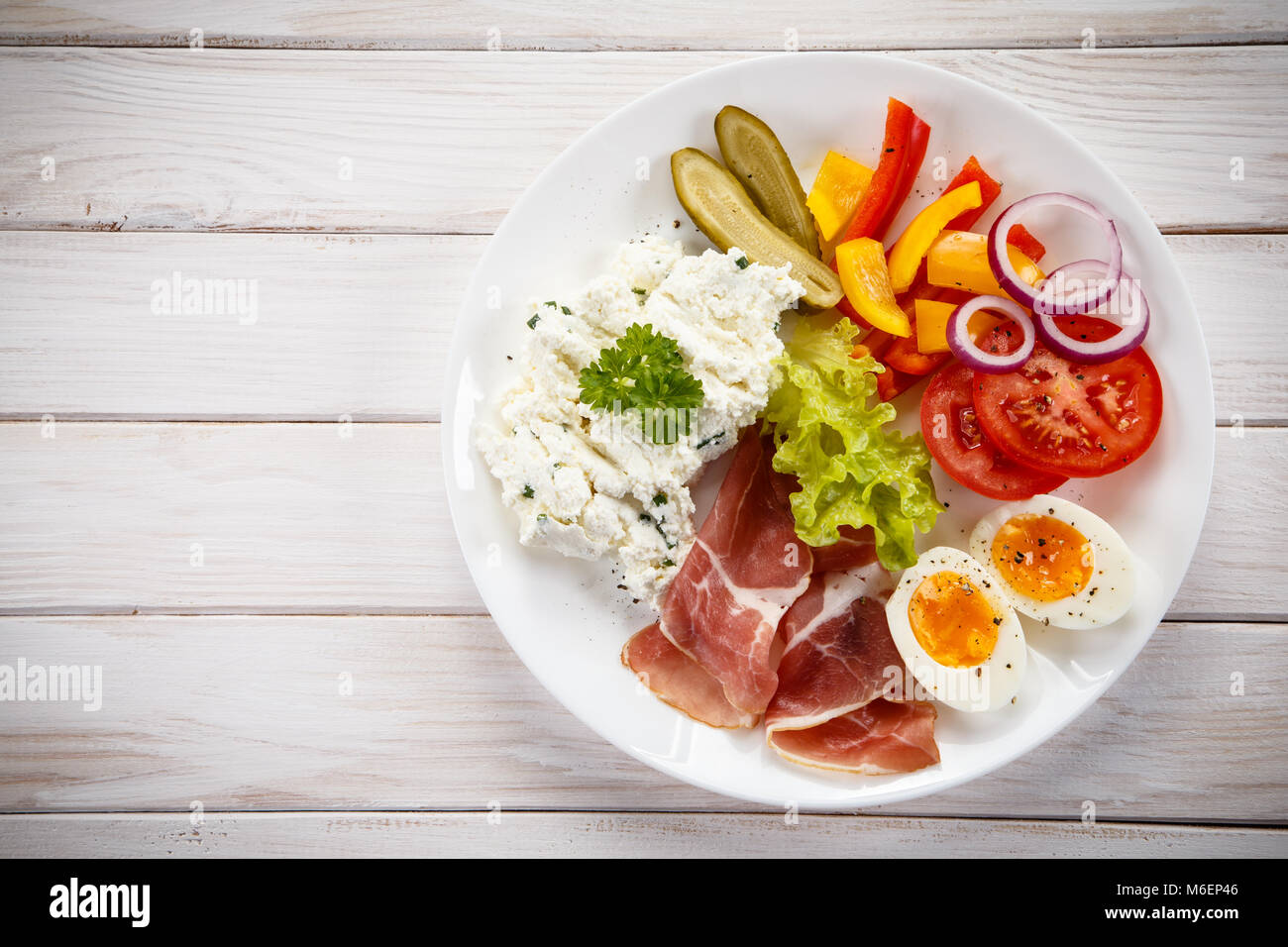 Breakfast boiled egg, bacon, cottage cheese and vegetables Stock